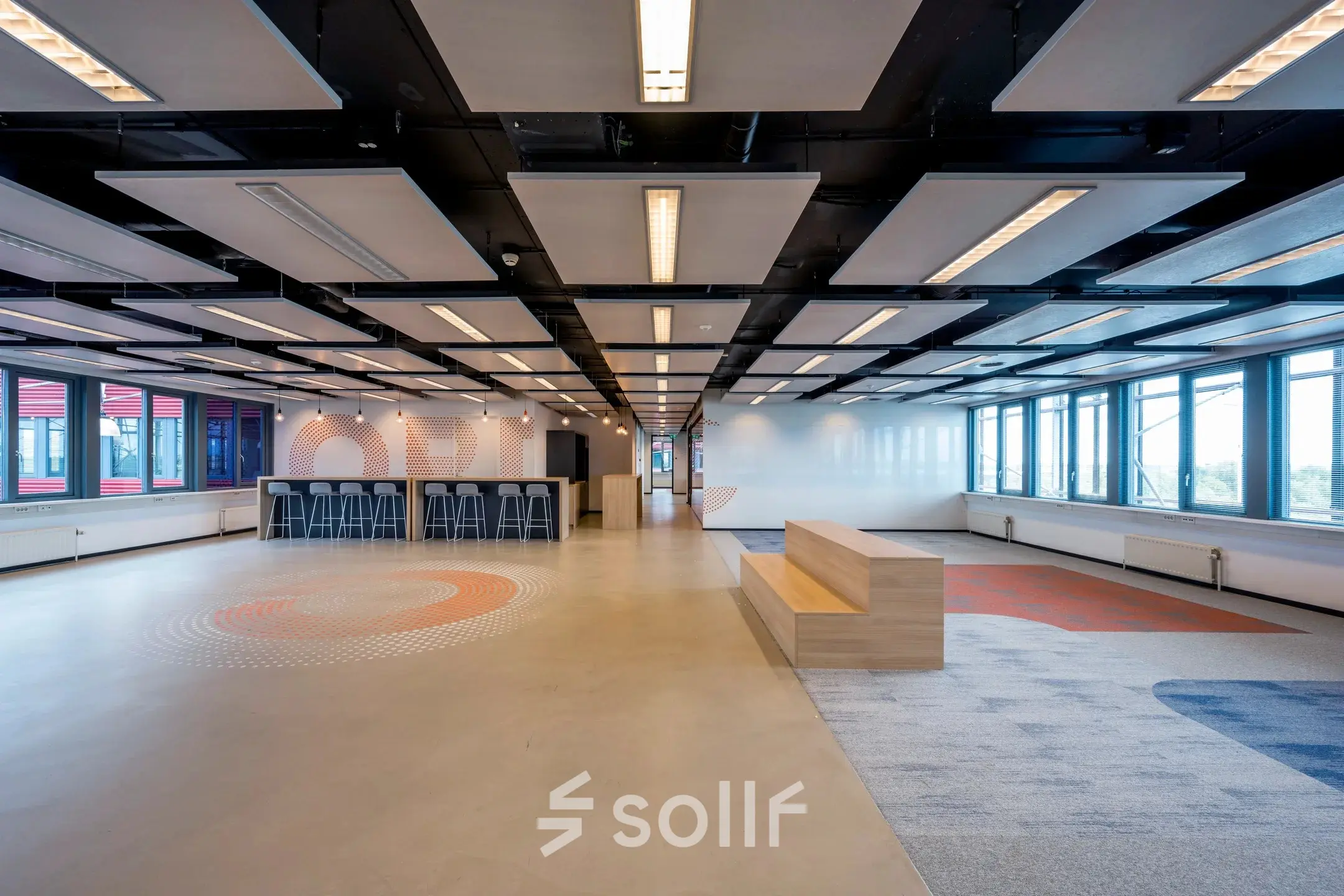Spacious, modern office space at Schiphol Airport with sleek design elements and ample seating, perfect for rental opportunities.