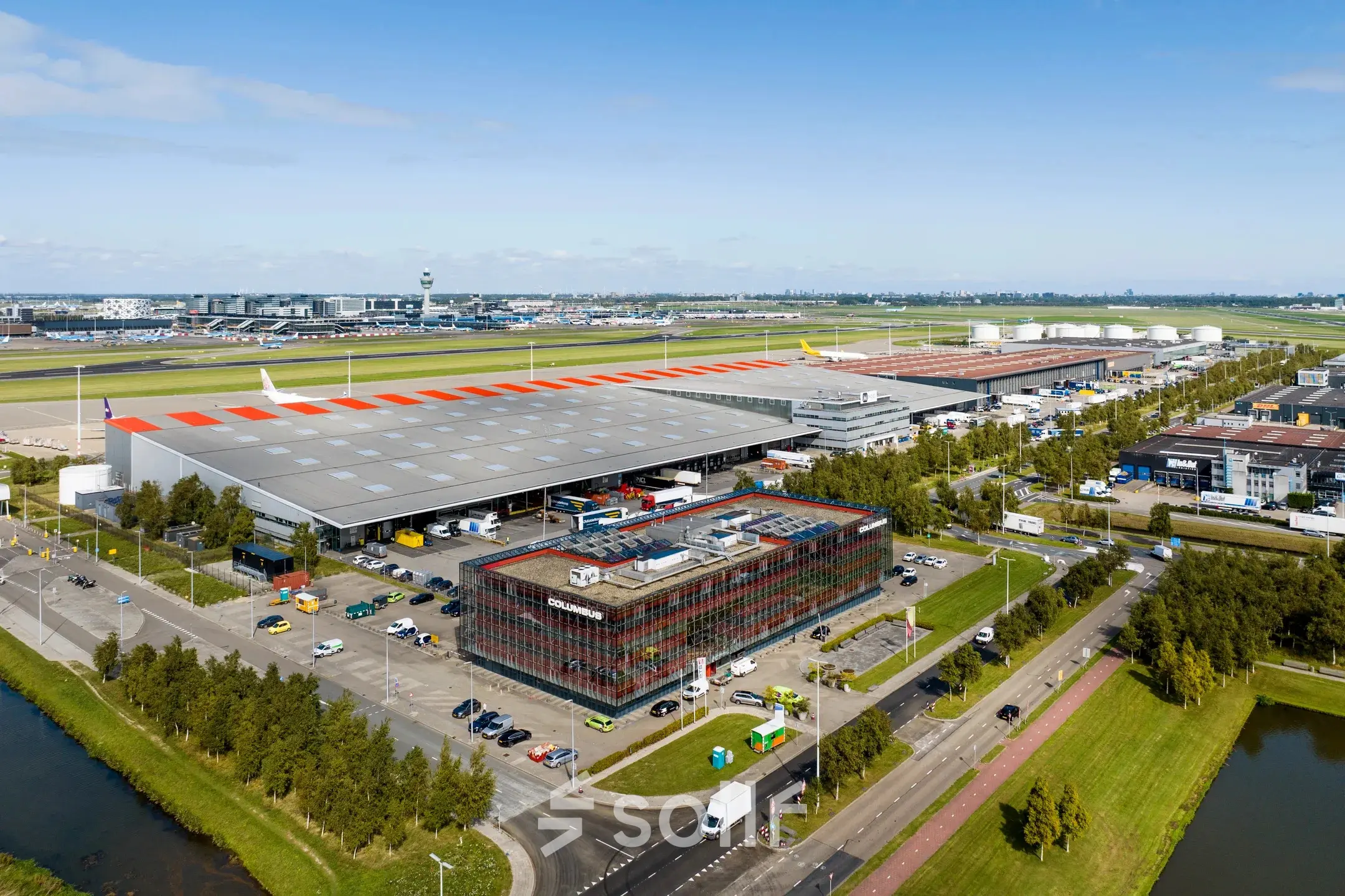 Aerial view of office space at Folkstoneweg 2-56, Schiphol Airport, surrounded by parking and industrial facilities.