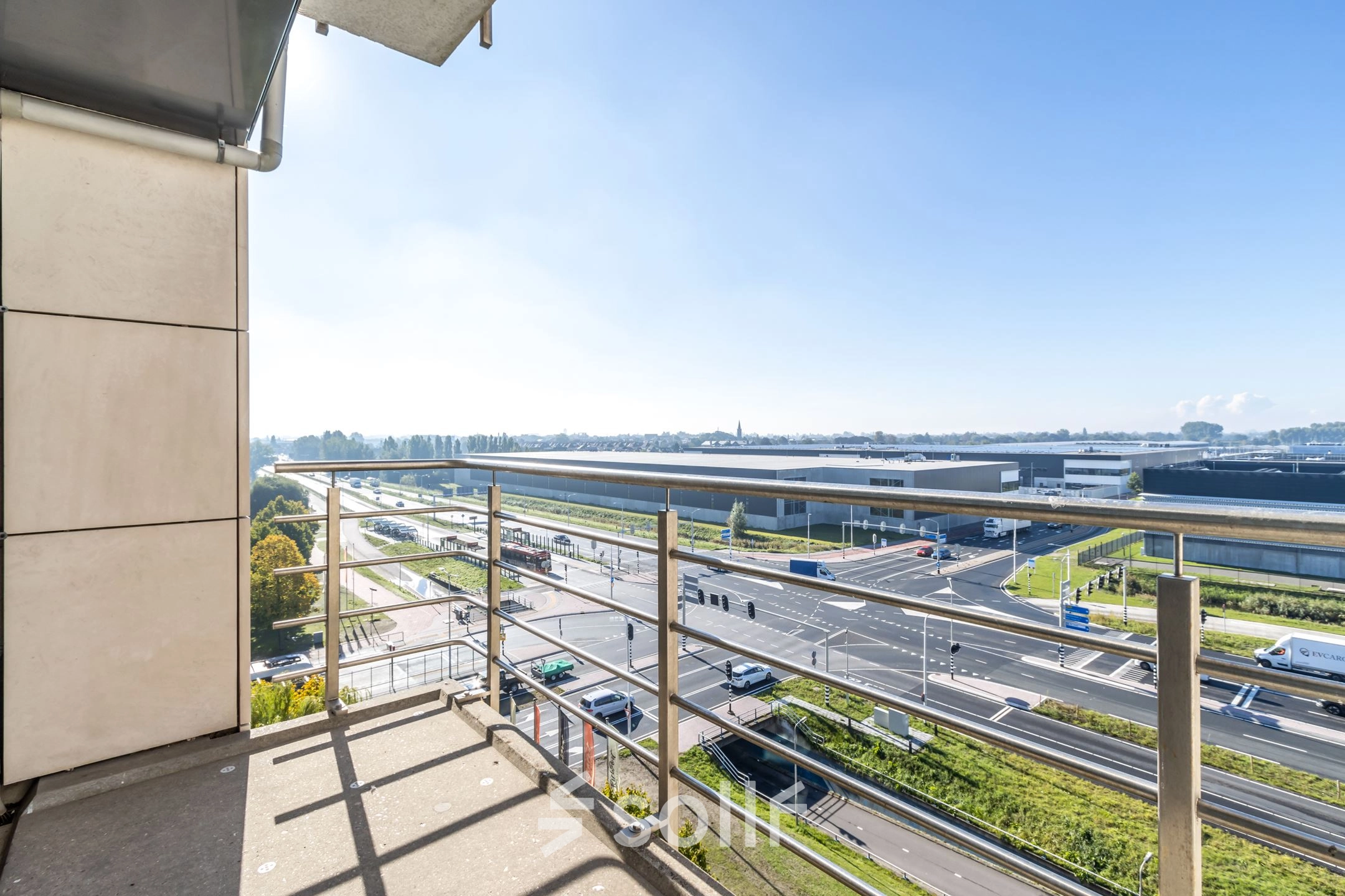 Exterior view from Beechavenue 54-100, Schiphol Rijk, showcasing a balcony overlooking roads and buildings, ideal for office space rental.
