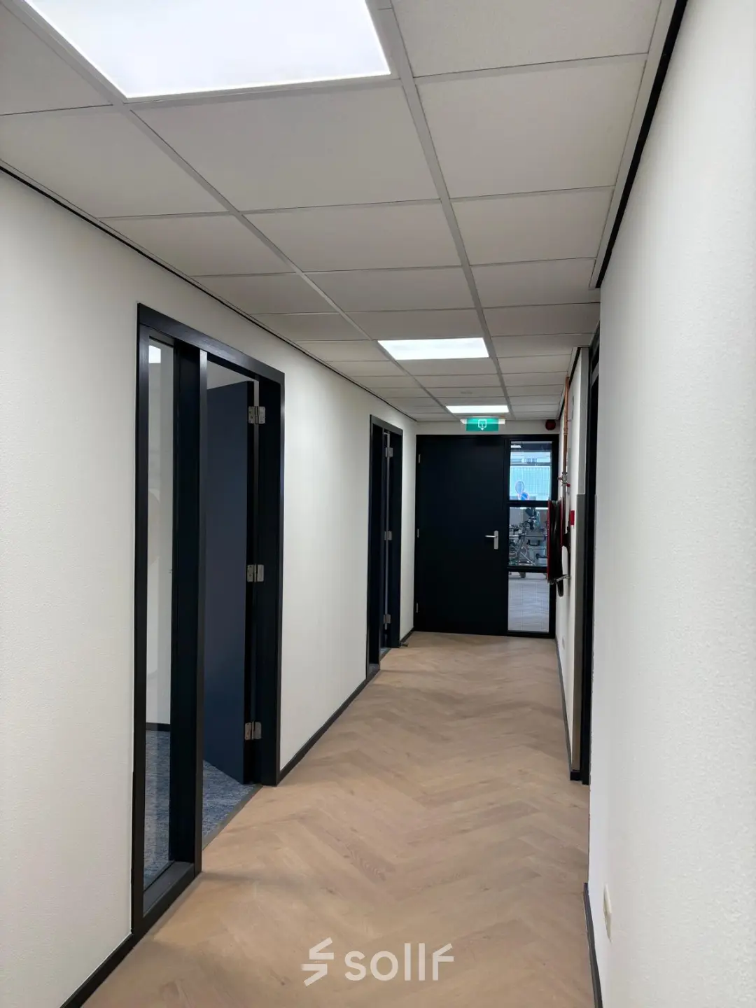 Hallway in an office located at Fischerpad 106, Sittard with wood flooring and closed office doors, available for office space rental.
