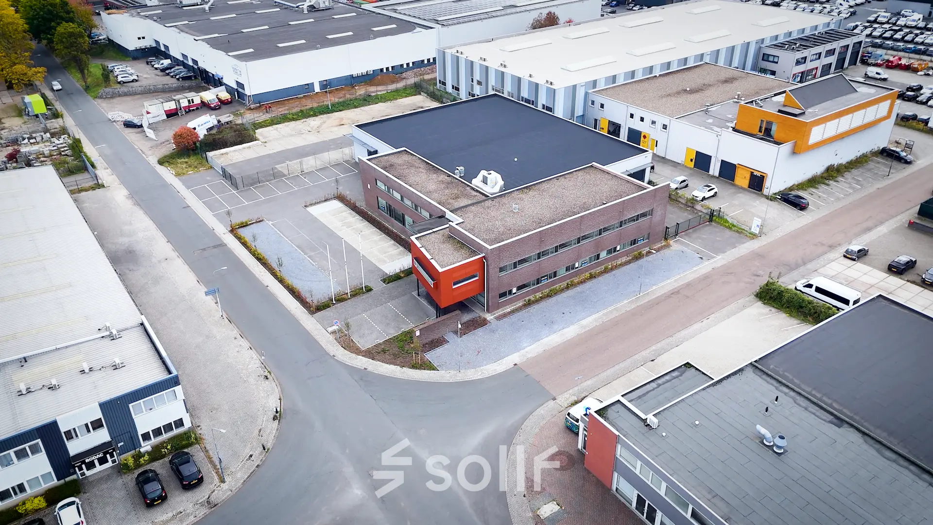 Aerial view of office building at Fischerpad 106, Sittard, ideal for office space rental. The building features a modern design with nearby parking options.