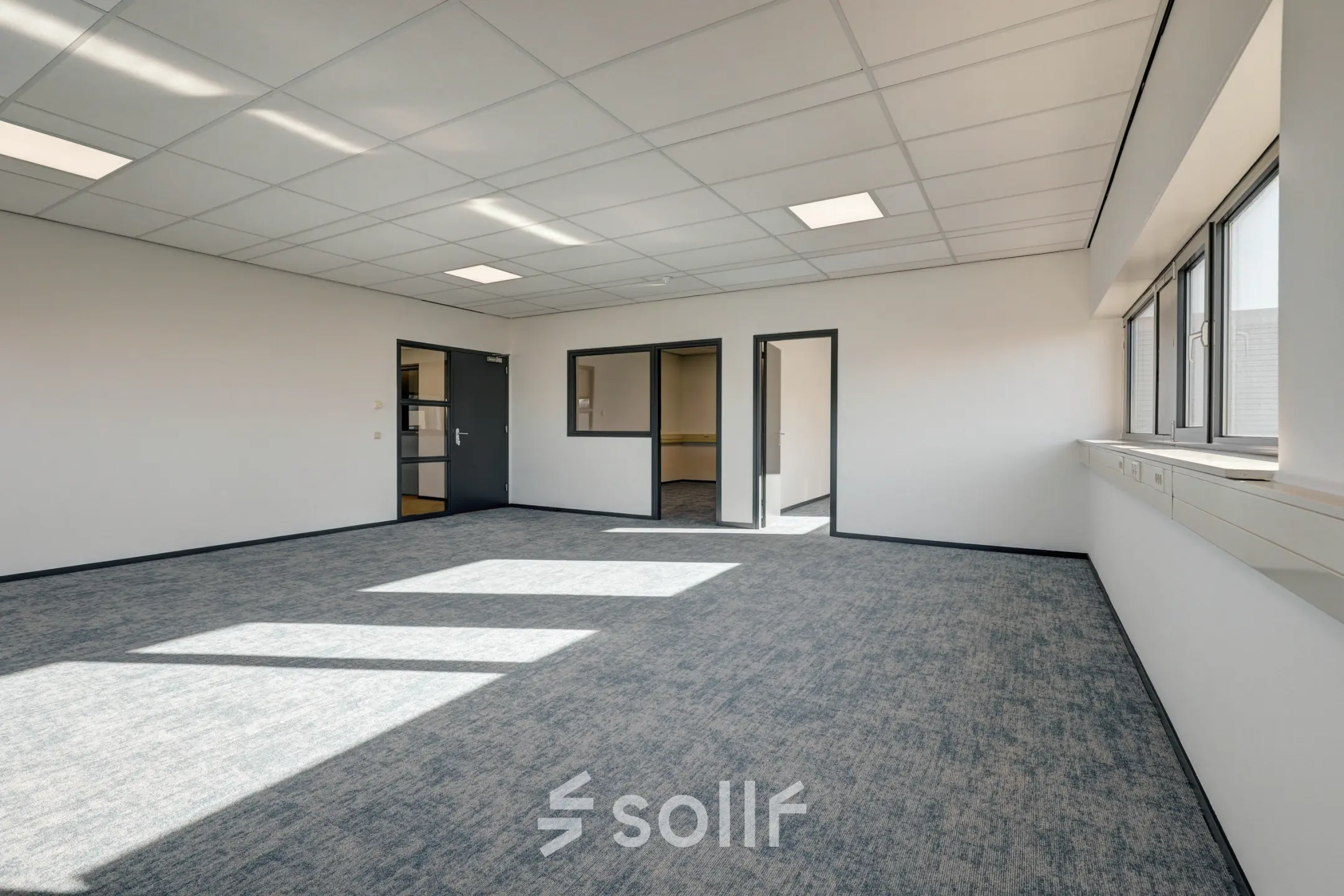 Bright office space at Fischerpad 106, Sittard with large windows and modern lighting, available for rent.