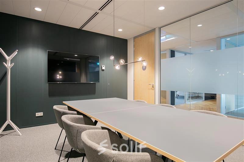 Modern conference room with a sleek table and comfortable chairs at Alexanderveld 5-9, The Hague Center, ideal for flexible office space rental.