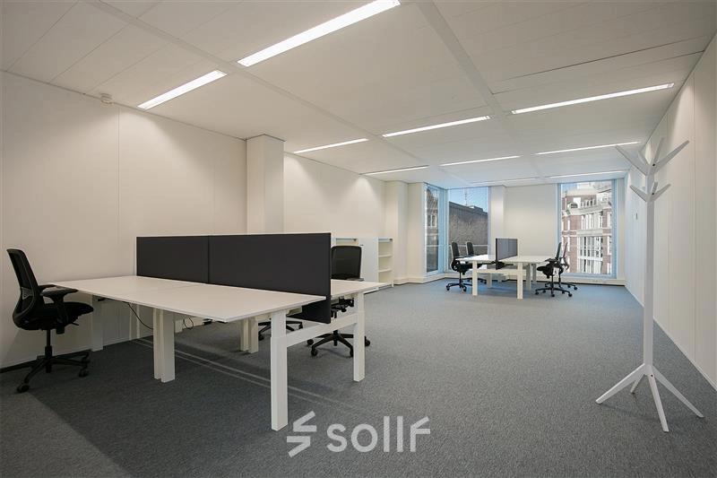 Bright and spacious open office space at Alexanderveld 5-9 in The Hague Center, featuring ample desks and modern ergonomic chairs, available for office space rental.