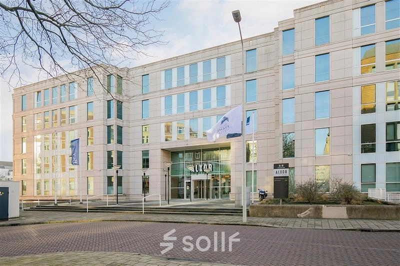 Exterior view of the Alexanderveld 5-9 office building in The Hague Center, highlighting modern design and ample windows. Ideal for office space rental.