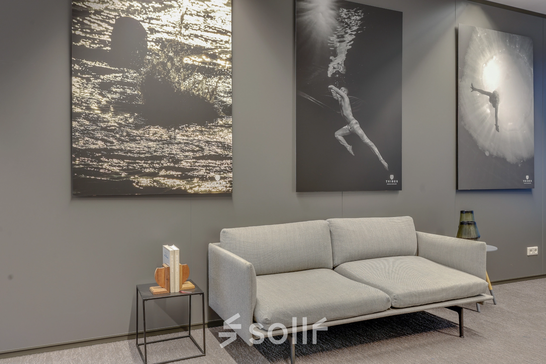 Furnished office space at Kalvermarkt 53, The Hague Center, featuring a modern grey sofa and art decor, ideal for rental or leasing opportunities.