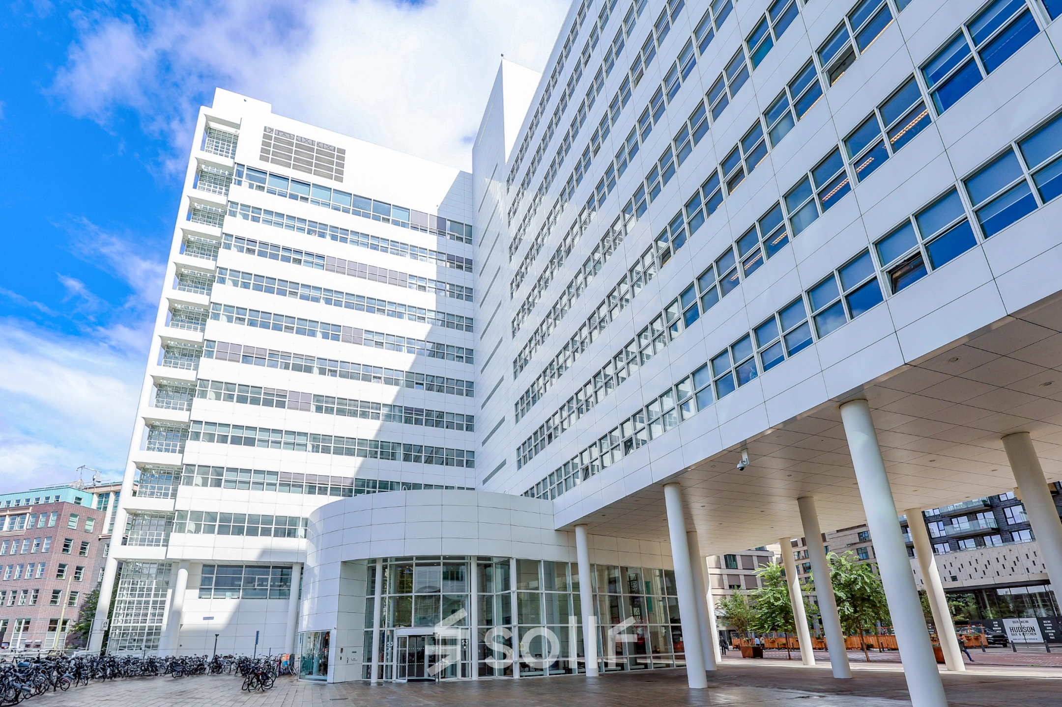 Exterior view of the modern office building at Kalvermarkt 53, The Hague Center, suitable for those seeking office space rental with ample light and sleek design.