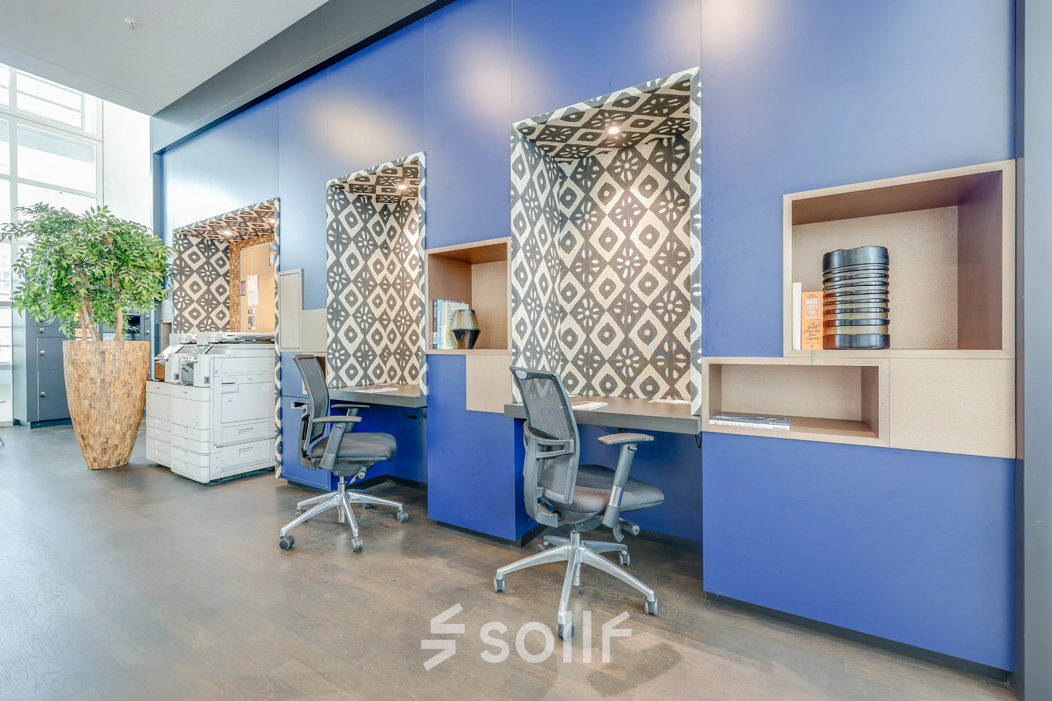 Modern office space with stylish blue accents and furnished workstations, available for rent office space at Kalvermarkt 53 in The Hague Center.