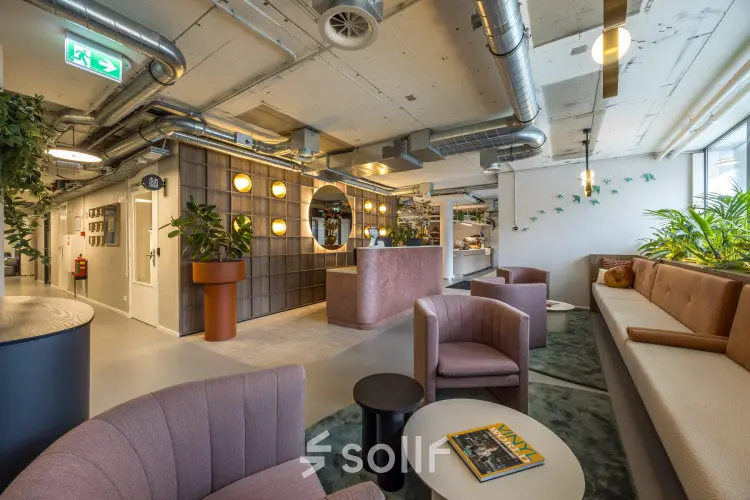 Stylish office space rental at Koninginnegracht 10, The Hague Center, featuring cozy seating and plants for a welcoming atmosphere.