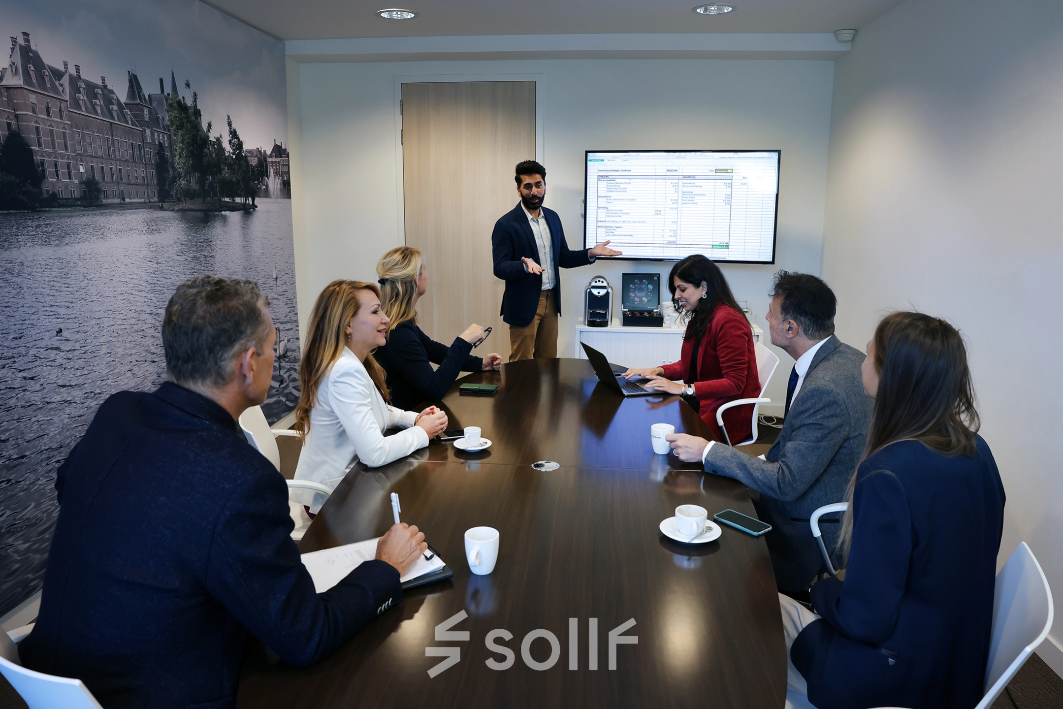 Engaged professionals in a conference room at Koninginnegracht 19 in The Hague Center discuss and present in an office space rental setting.