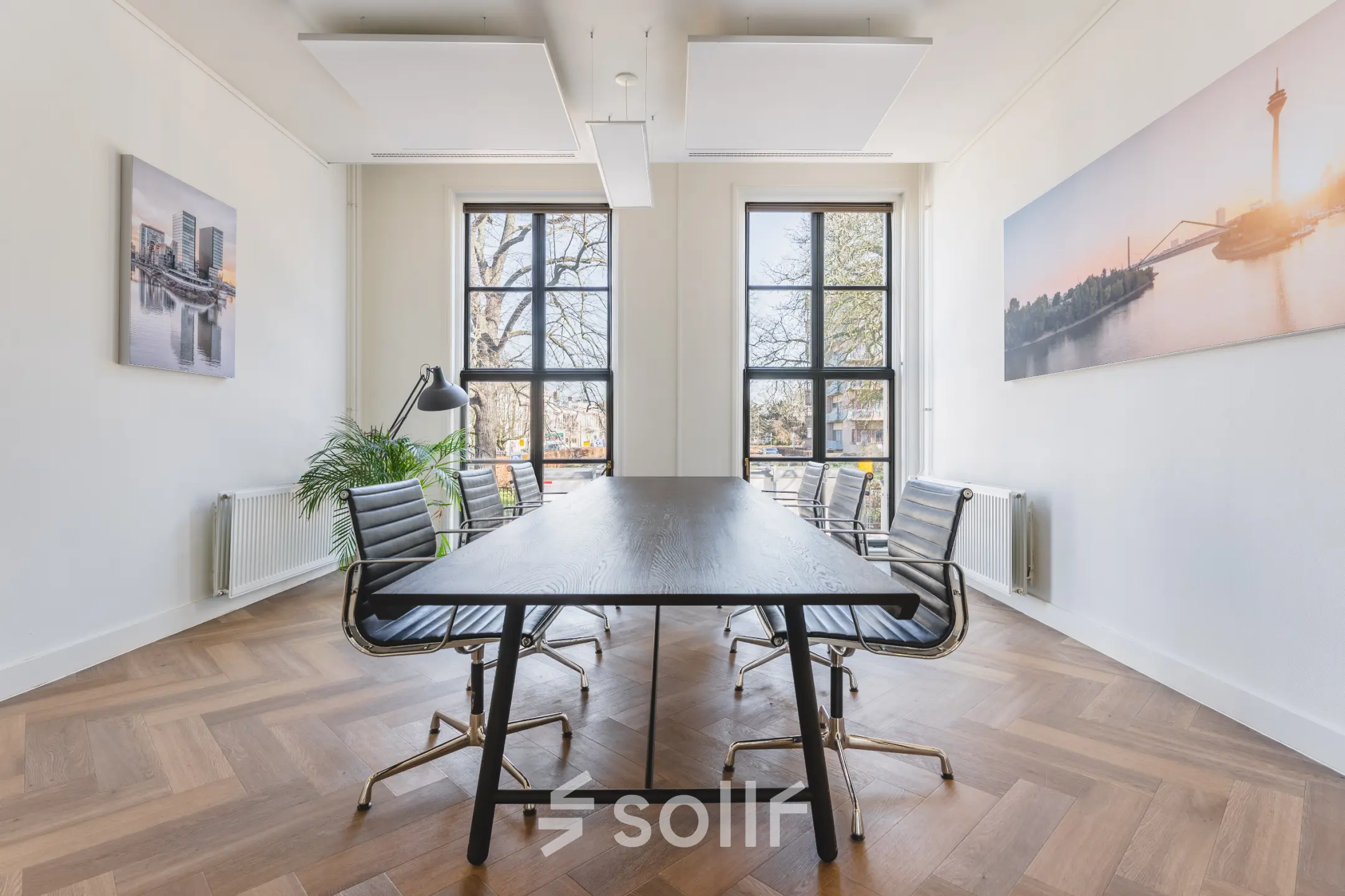 Bright office at Zeestraat 100, The Hague Center, featuring large windows, a sleek table, and stylish chairs. Perfect spot for your next office space rental.