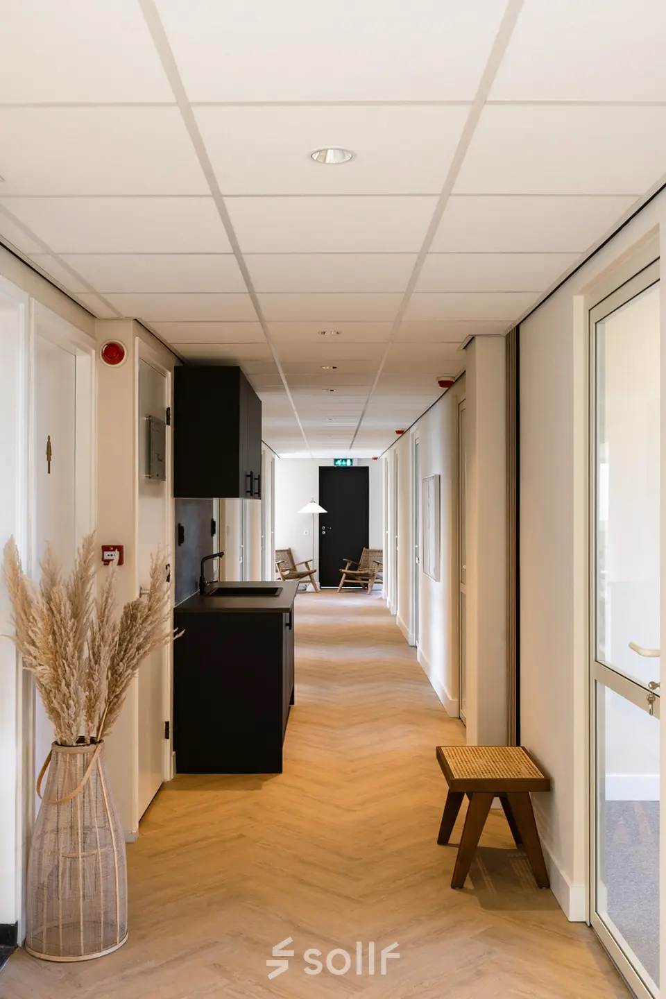 Hallway at Zeestraat 100 in The Hague Center with seating and natural decor, ideal for office space rental.