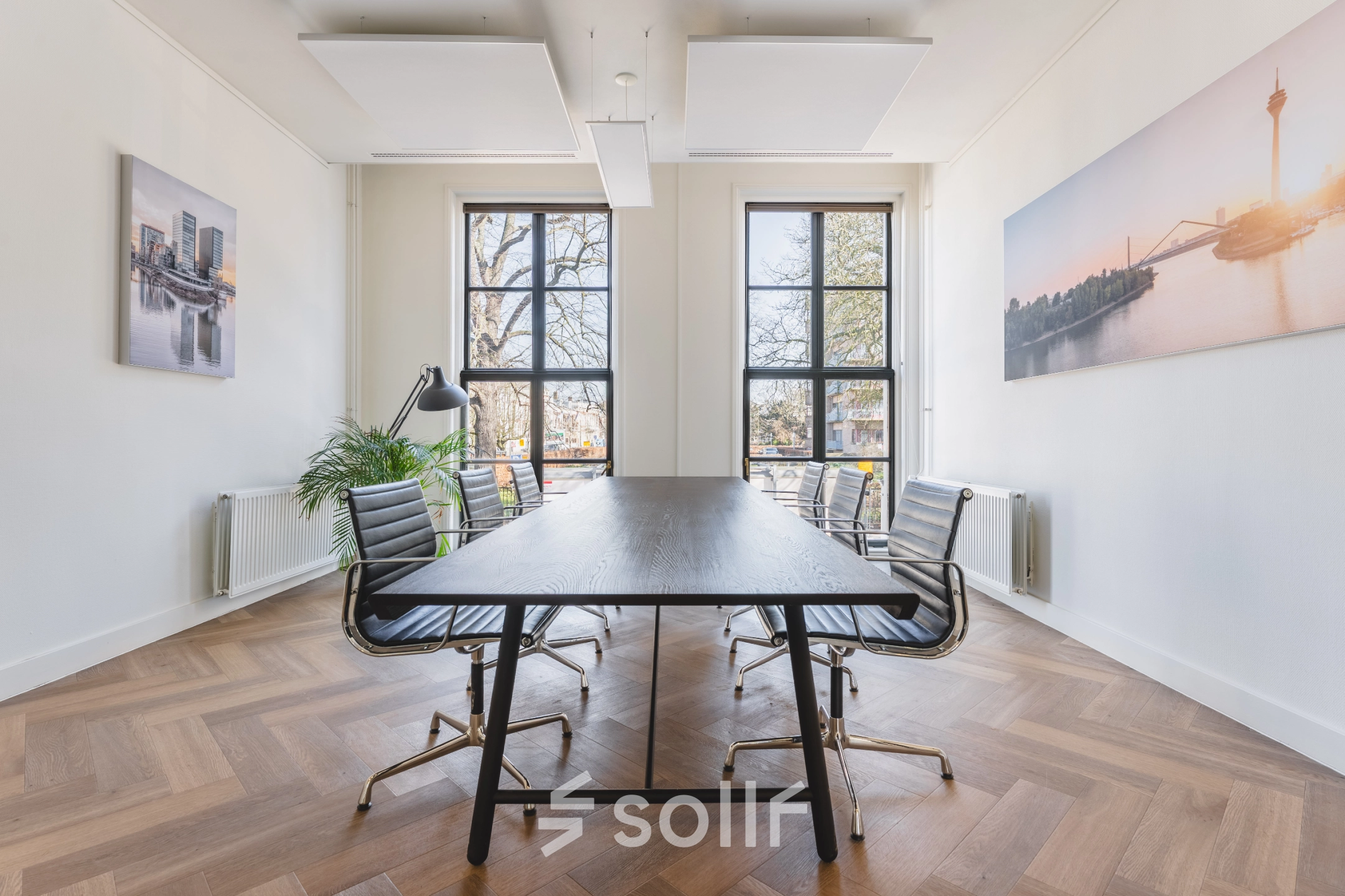 Bright, furnished office space with a long table and chairs, perfect for an office space rental in The Hague Center.