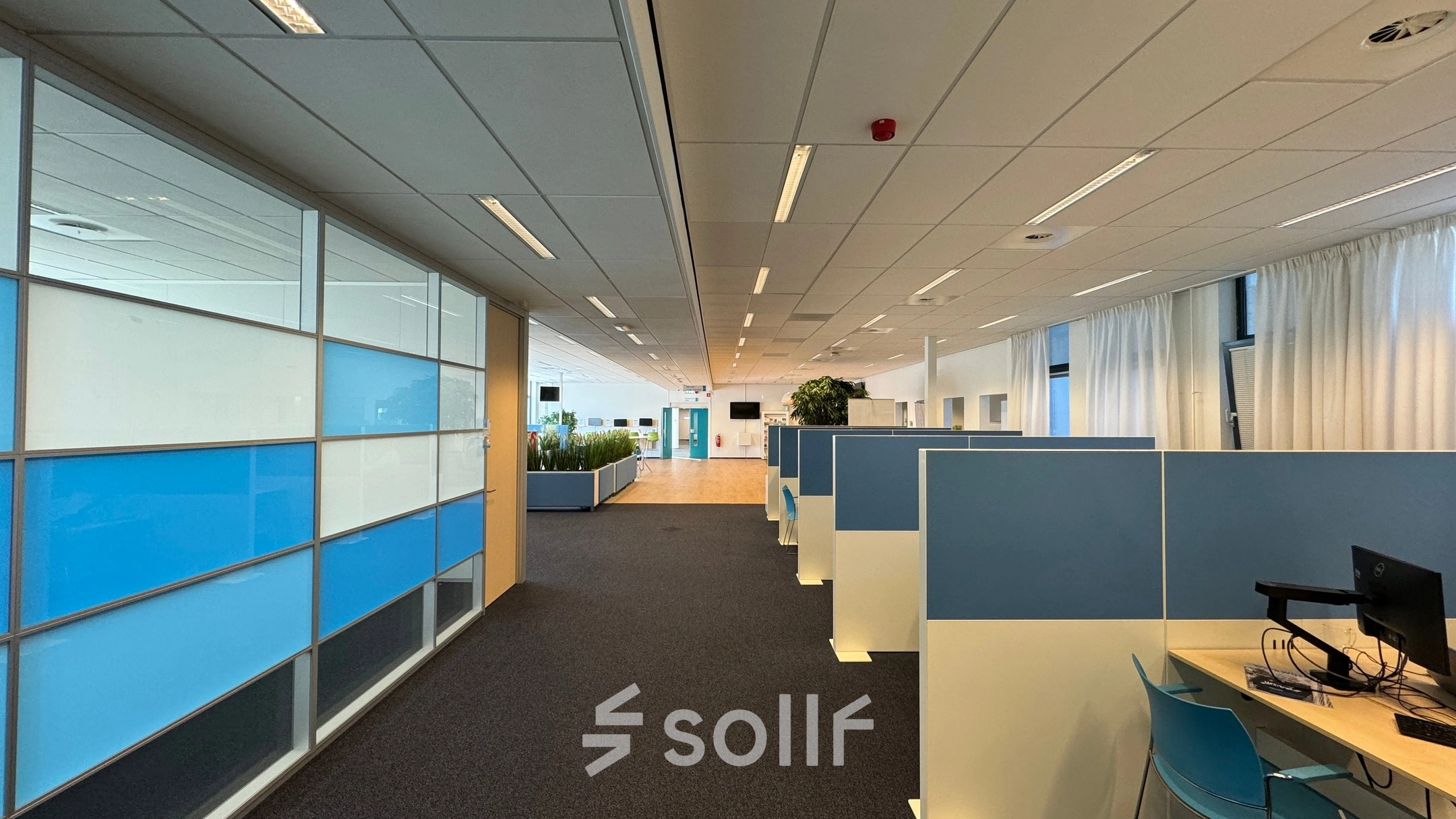 Open floorplan office interior at Platinaweg 10, The Hague Escamp, featuring modern cubicles, sleek design, and ample natural light. Ideal for those seeking an office space rental with contemporary workspaces.