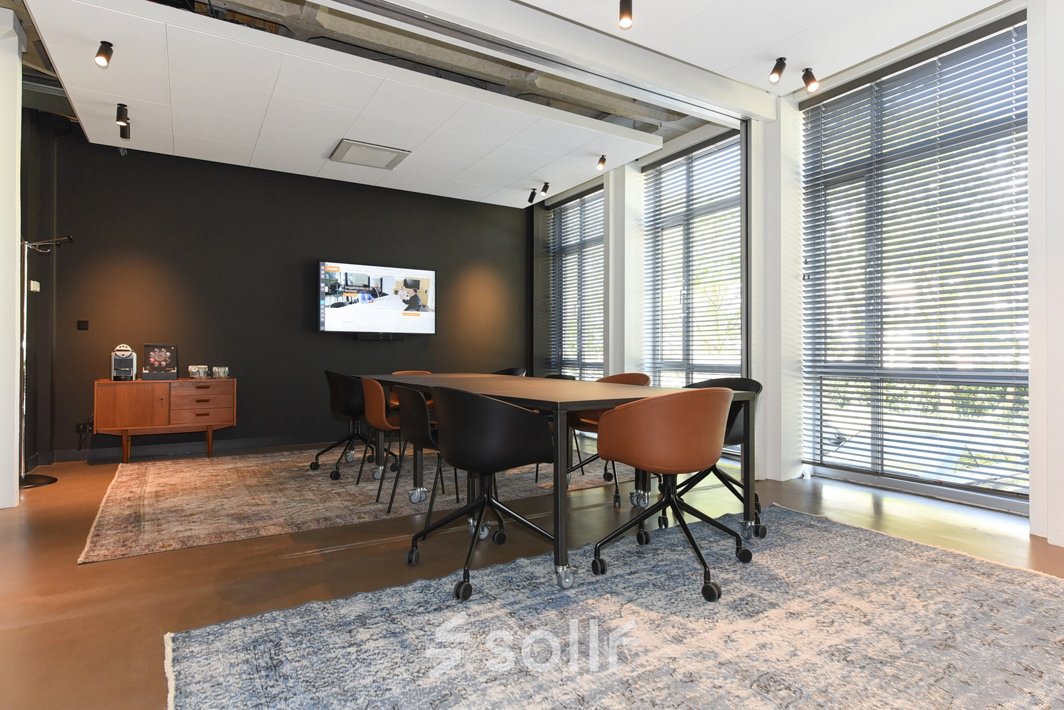 Furnished conference room with a large table and chairs, suitable for office space rental at President Kennedylaan 19, The Hague Statenkwartier.