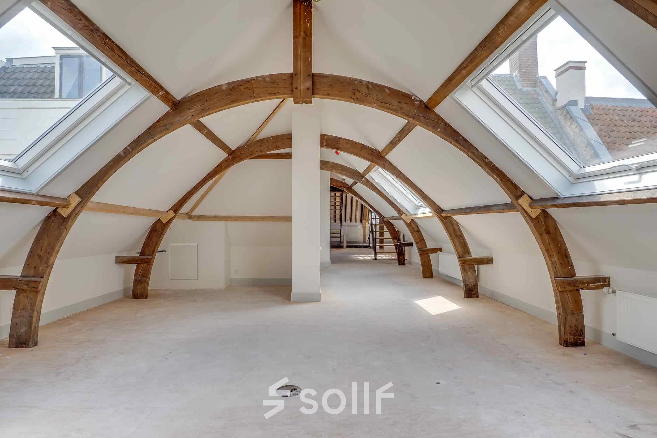 Spacious attic office space with wooden beams and skylights at Brigittenstraat 22, Utrecht Center, ideal for unique office space rental.