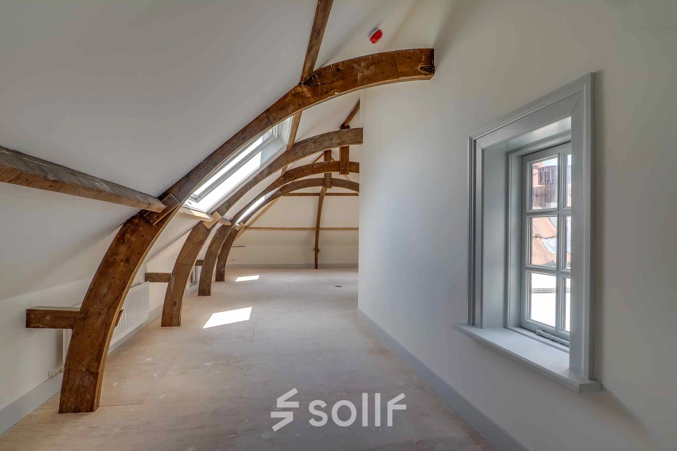 Spacious office to rent at Brigittenstraat 22, Utrecht Center featuring exposed wooden beams and ample natural light, ideal for flexible office space rental.