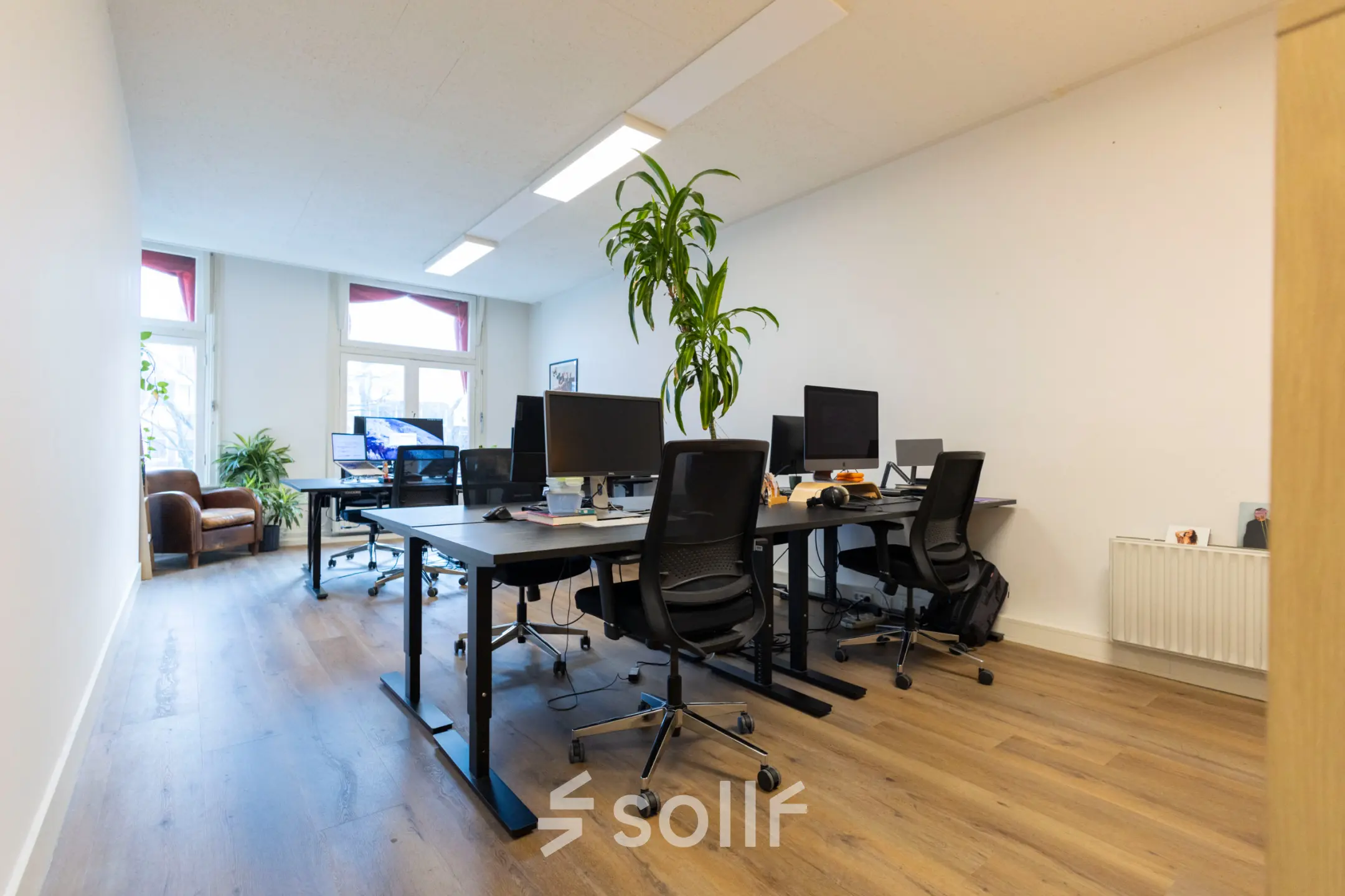 Bright office space at Oudegracht 161, Utrecht Center, featuring desks with computers and chairs, ideal for office space rental needs.