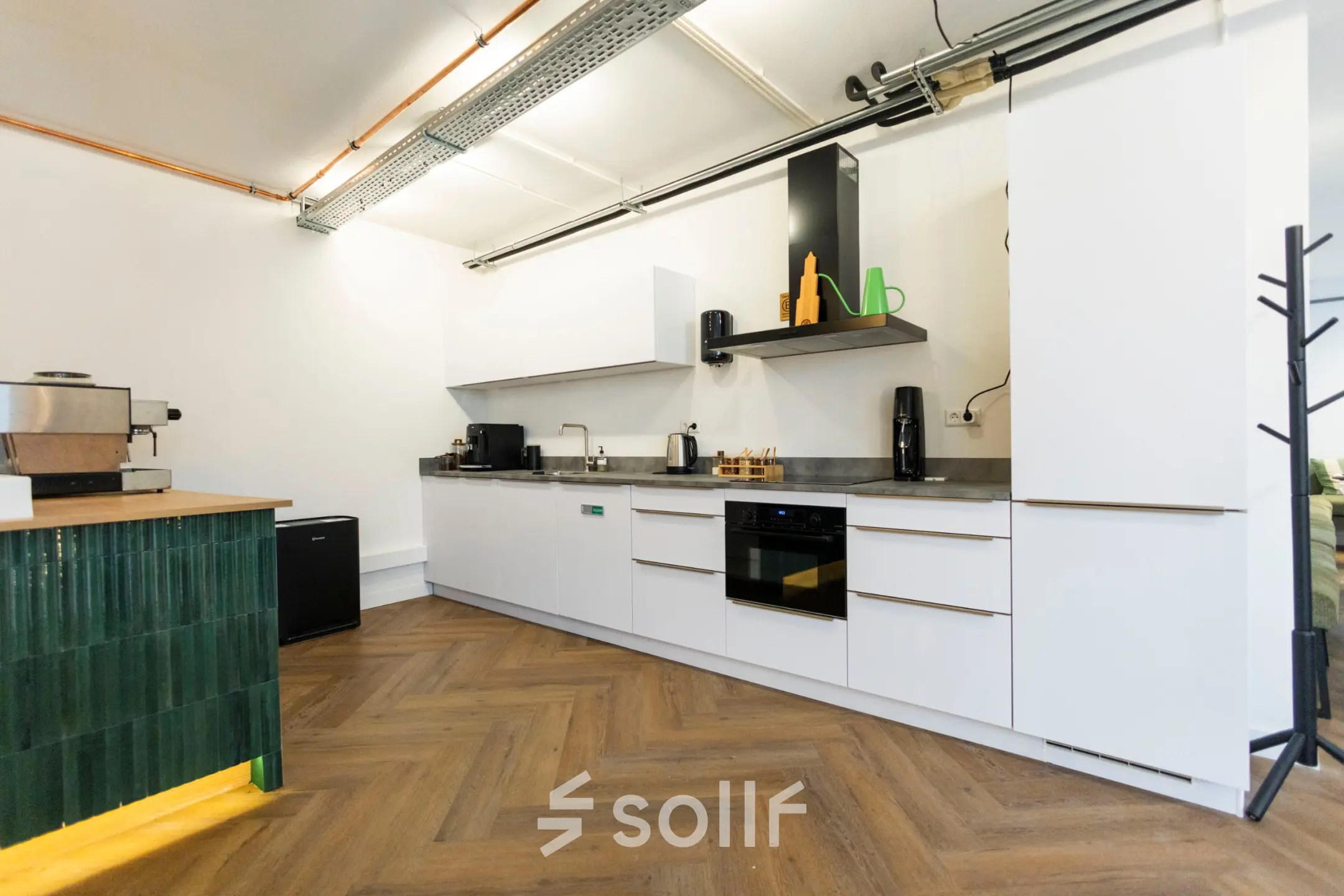 Modern office kitchenette with sleek cabinetry and appliances at Oudegracht 161, ideal for office space rental in Utrecht Center.
