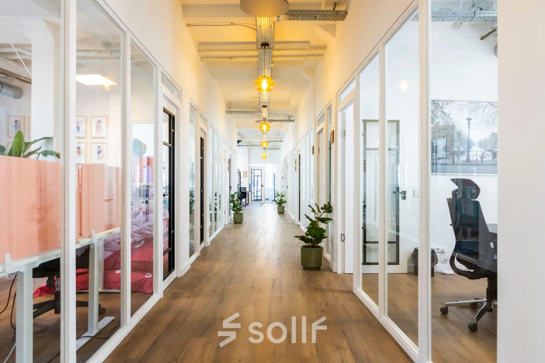 Modern office interior at Oudegracht 161, Utrecht Center, featuring a corridor with glass-walled workspaces available for office space rental.
