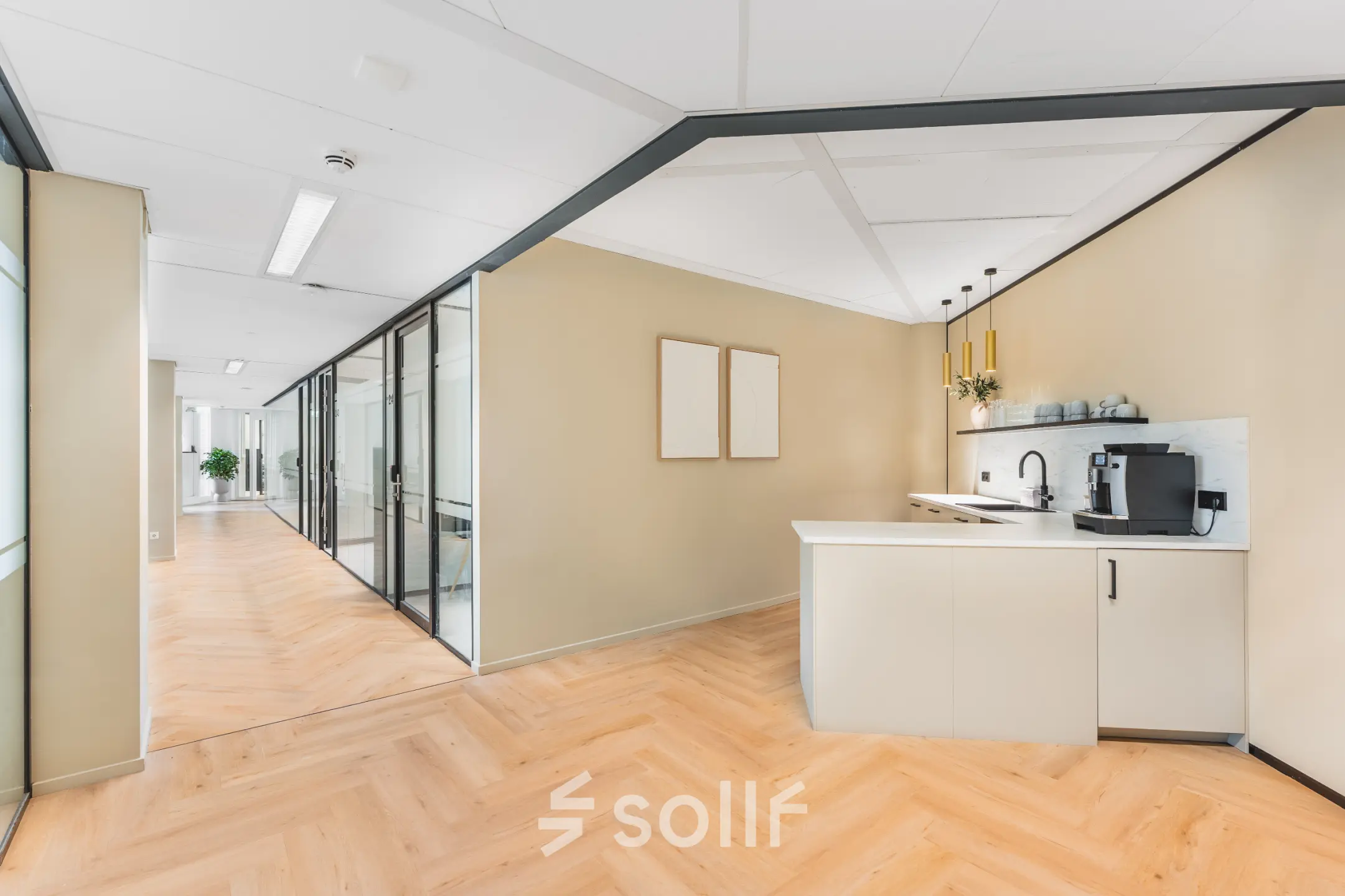 Bright, modern office interior at Leidseveer 2-10, Utrecht Central Station, featuring glass-partitioned workspaces and a kitchenette, available for office space rental.