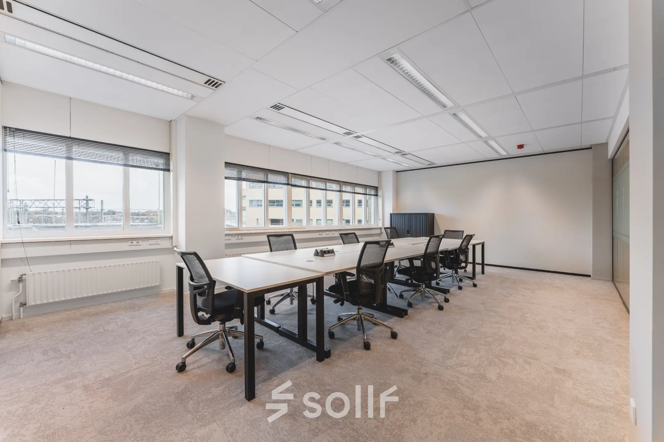 A spacious office in Utrecht Central Station at Leidseveer 2-10, featuring desks and chairs suitable for office space rental.