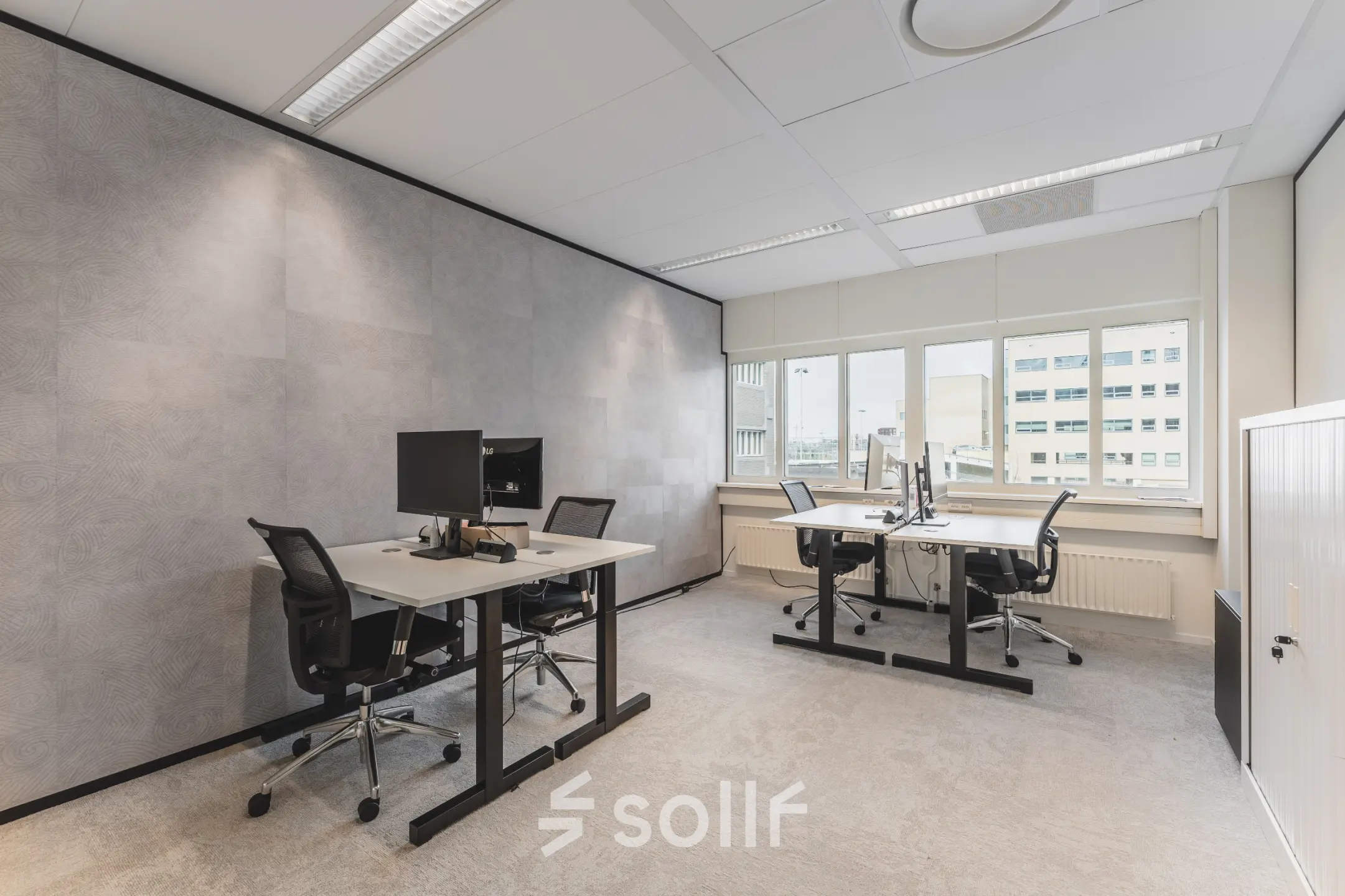 Furnished office space at Leidseveer 2-10, Utrecht Central Station, featuring desks and chairs with computers for office space rental.