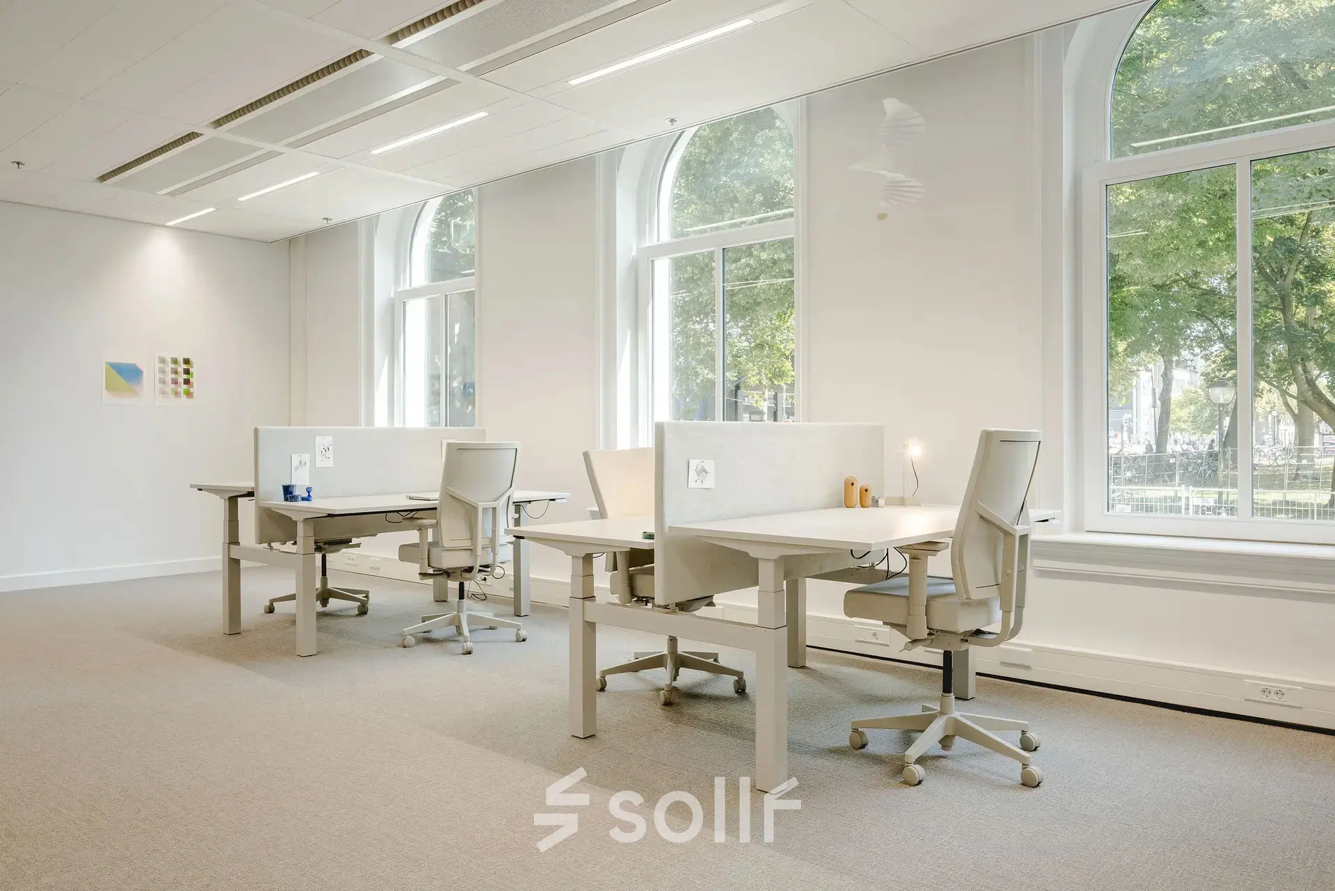 Bright office space at Moreelsepark 1, Utrecht Central Station, with large windows and desks for rent.