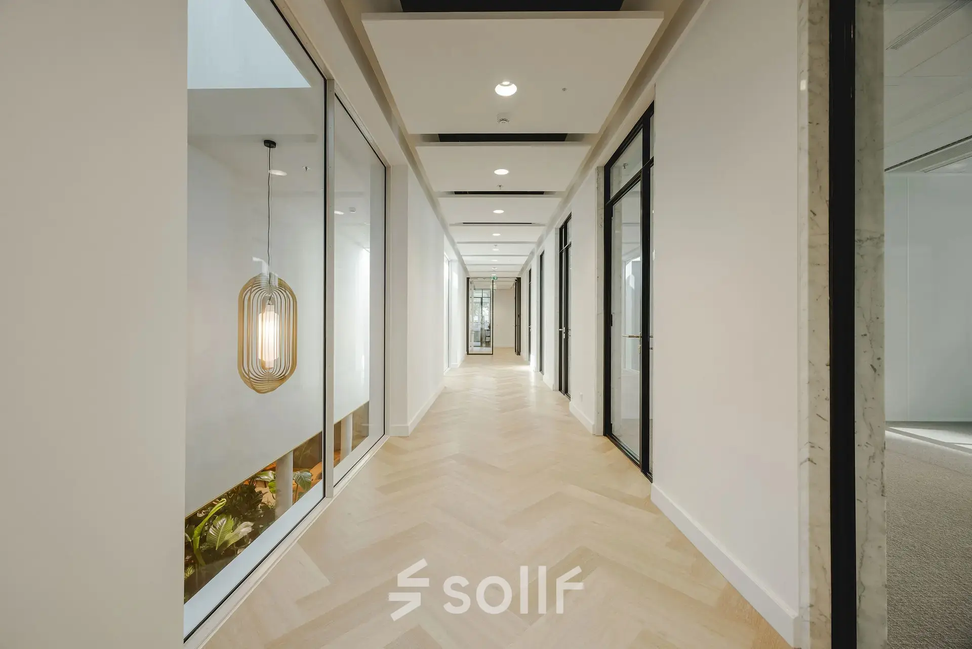 Bright hallway at Moreelsepark 1, Utrecht Central Station, ideal for office space rental with sleek design and modern lighting.