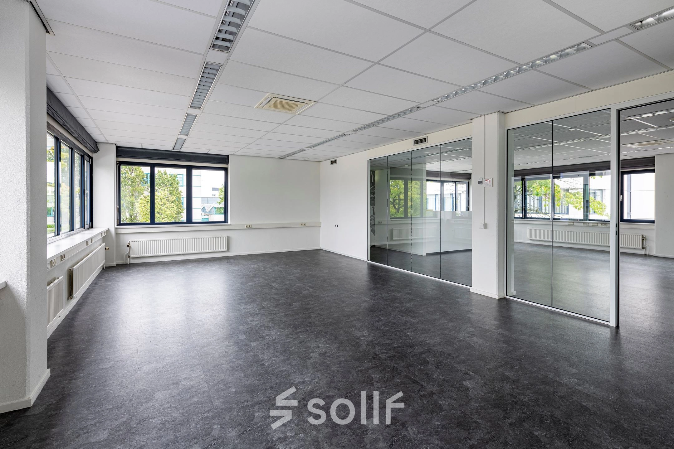 Spacious office to rent with large windows and reflective glass walls in Utrecht Lage Weide, ideal for customizable workspace setup.