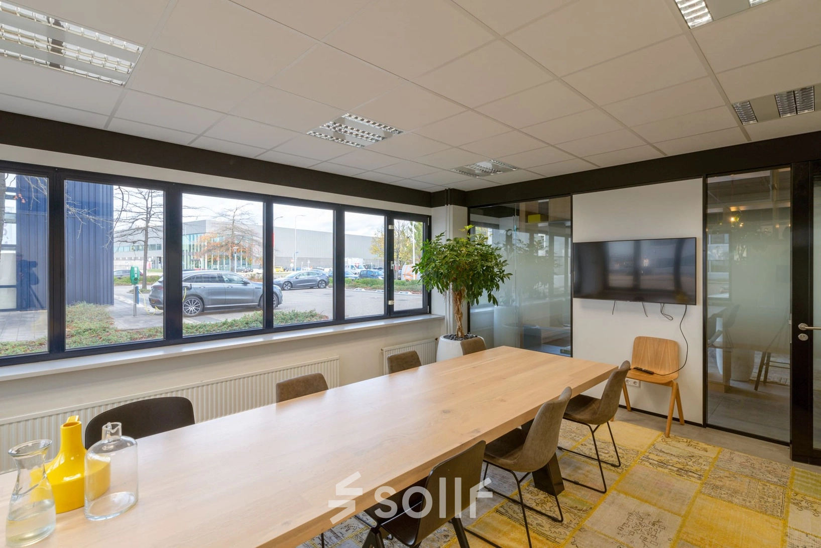 Modern office space at Atoomweg 400, Utrecht Lage Weide with a large table, chairs, and a TV, available for office space rental.