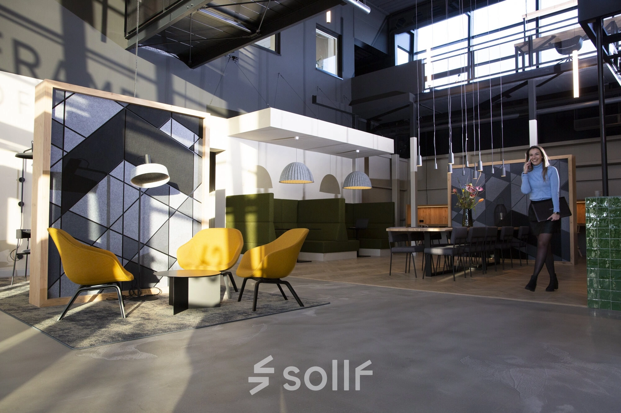 Modern office space at Atoomweg 63, Utrecht Lage Weide, featuring stylish furnishings and a professional ambiance. A person is making a phone call in the workspace area, suitable for office space rental.