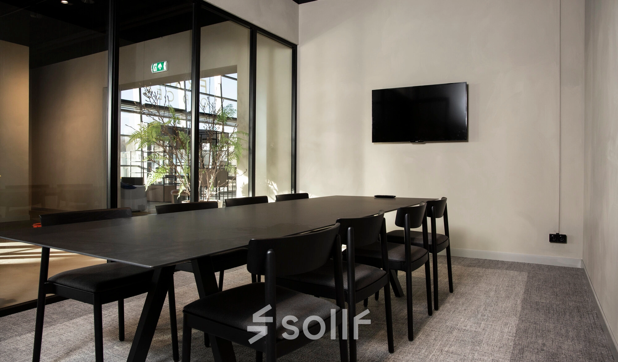 Conference room available for office space rental at Atoomweg 63, Utrecht Lage Weide, featuring a sleek meeting table, chairs, and a wall-mounted TV.