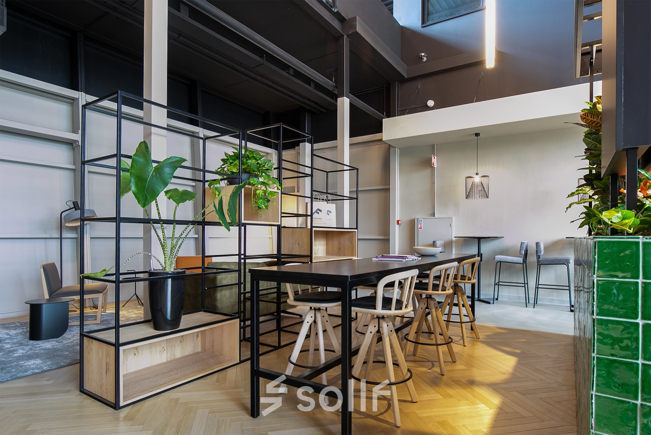 Modern office space with sleek furnishings and green plants at Atoomweg 63 in Utrecht Lage Weide, suitable for those seeking office space rental.