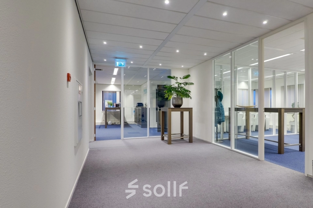 Modern office space at Atoomweg 63, Utrecht Lage Weide, featuring a clean, furnished interior with glass partitions and plants. Ideal for office space rental.