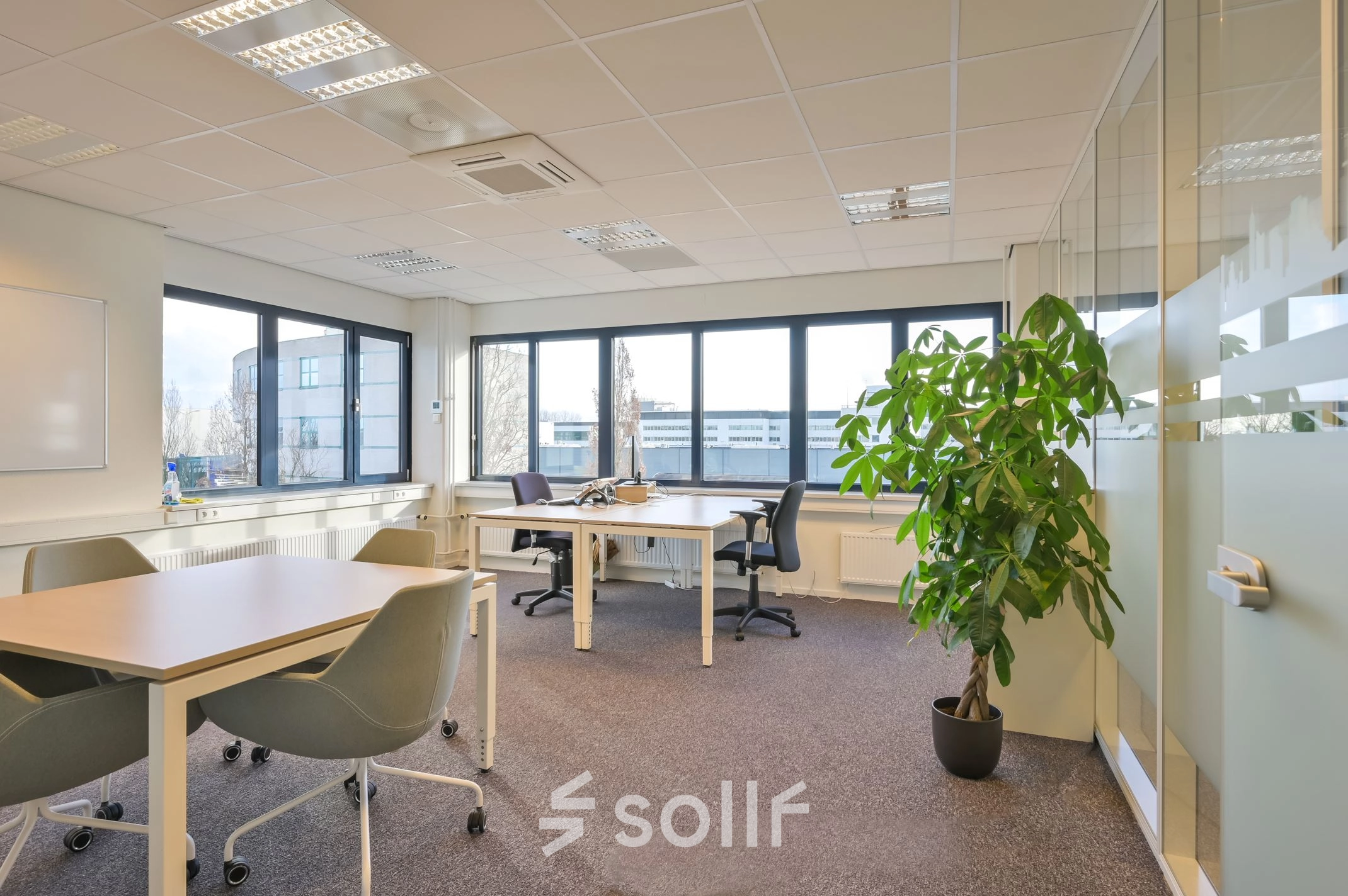 Bright furnished office space at Kobaltweg 11, Utrecht Lage Weide, featuring modern desks and chairs with large windows providing natural light.