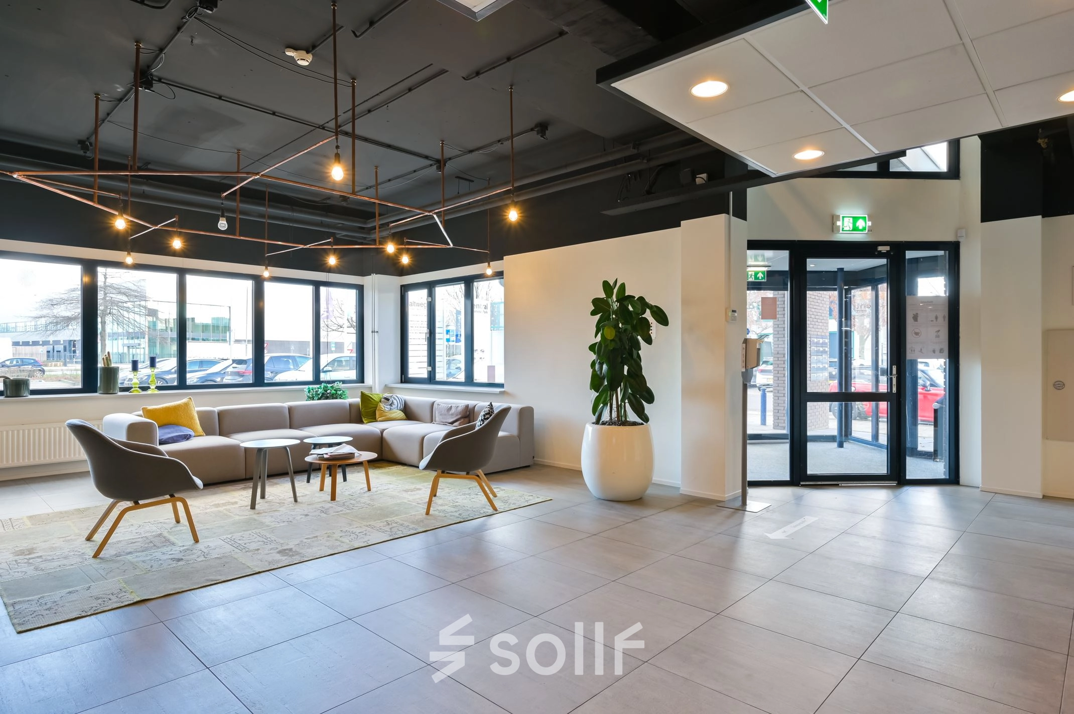 Bright and airy office entrance at Kobaltweg 11 in Utrecht Lage Weide, featuring modern seating and greenery. Ideal for office space rental.