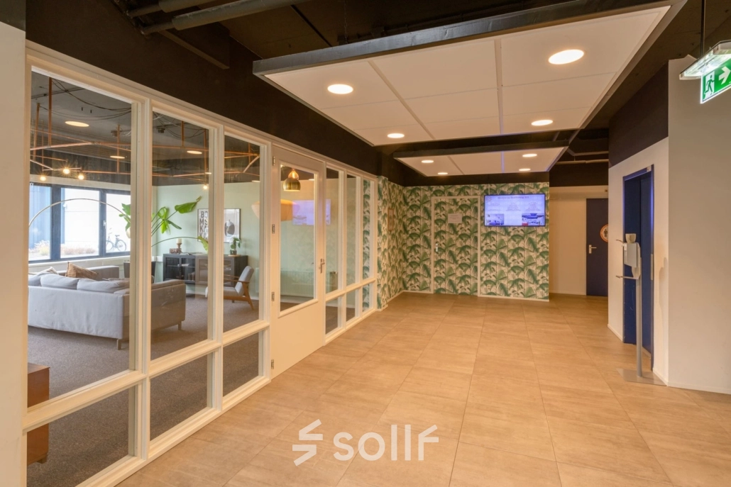 Entrance area with tiled flooring and large windows, leading to office spaces available for rent at Utrecht Lage Weide on Reactorweg 301.