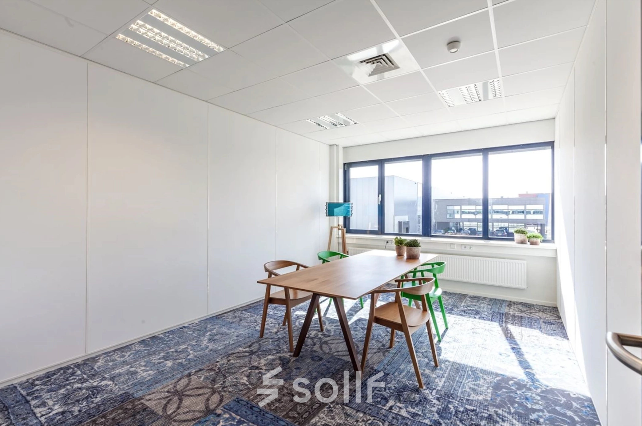 Bright furnished office space at Reactorweg 301, Utrecht Lage Weide, featuring a table, chairs, and natural light, suitable for office space rental.