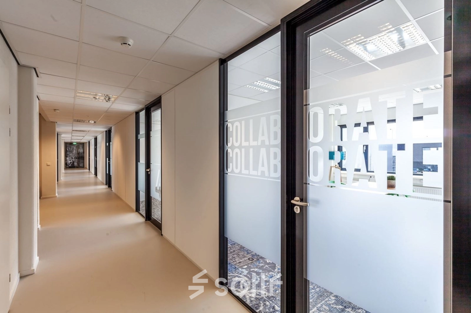 A hallway in an office space at Reactorweg 301, Utrecht Lage Weide, featuring glass doors labeled 'Collaborate'. An ideal office space rental opportunity.