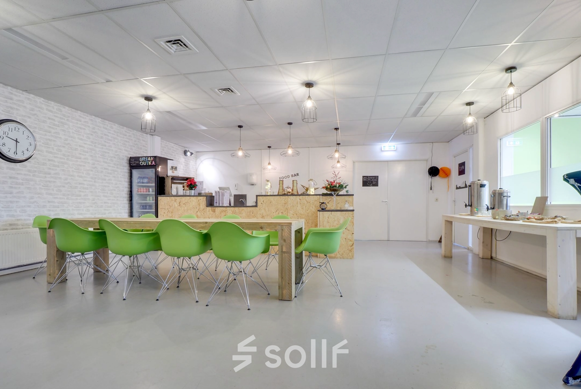 Modern office break area at Zonnebaan 18, Utrecht Lage Weide, with green chairs and a communal table. Ideal office space rental option.