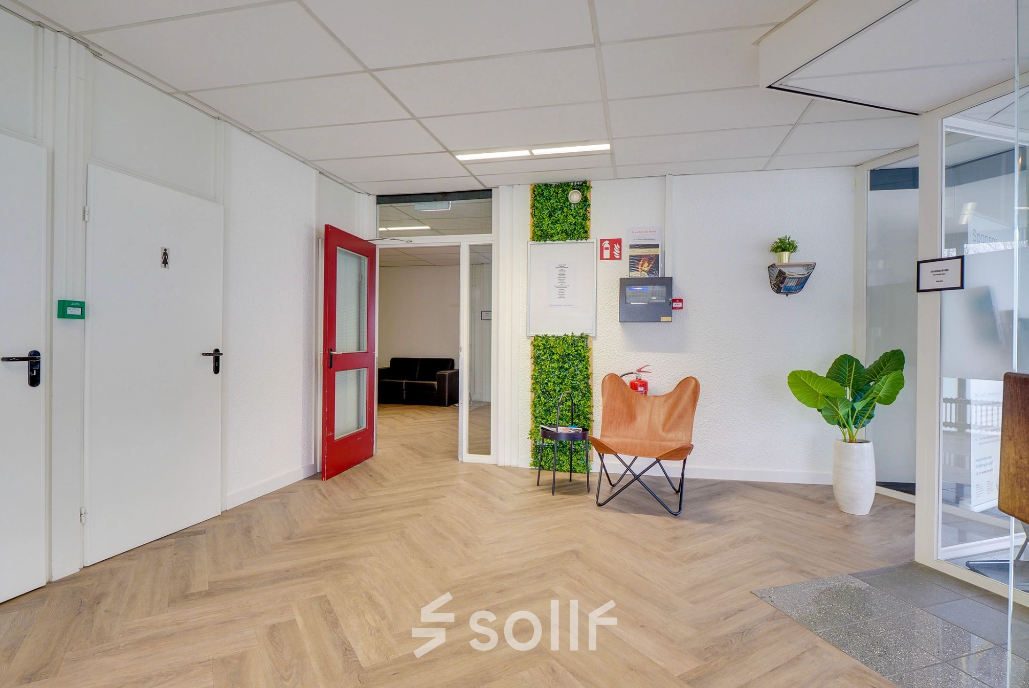 Bright office interior at Zonnebaan 18, Utrecht Lage Weide with wooden flooring, modern decor, and seating area, available for office space rental.