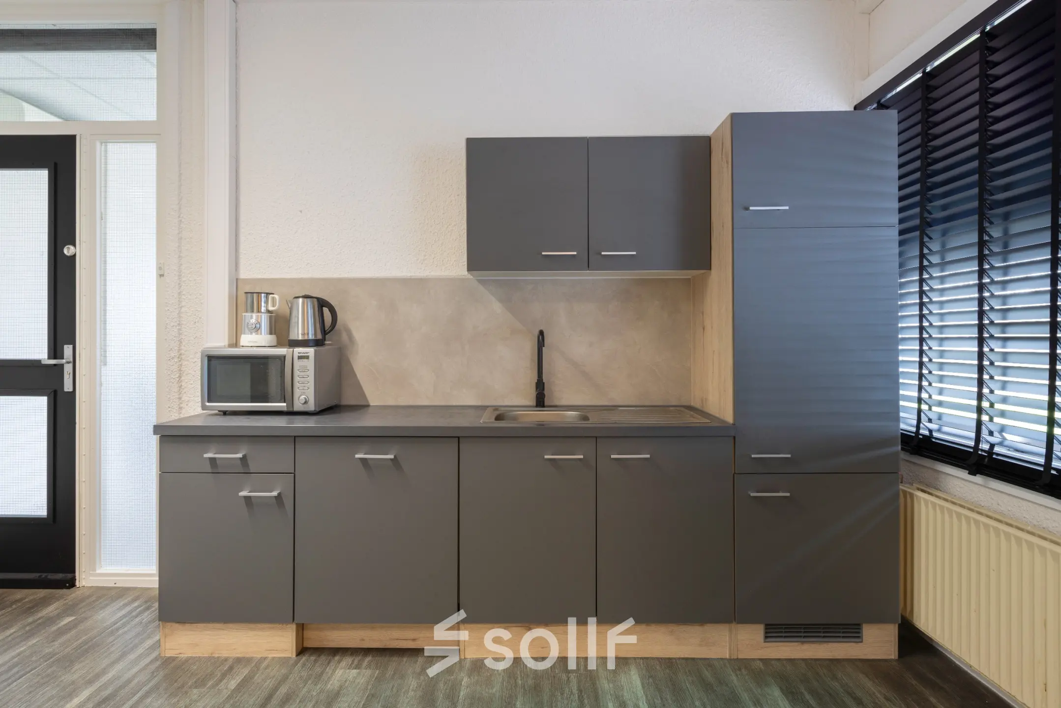 Compact kitchenette in an office space at Zonnebaan 18, Utrecht Lage Weide, featuring modern cabinets and essential appliances for convenient office space rental.