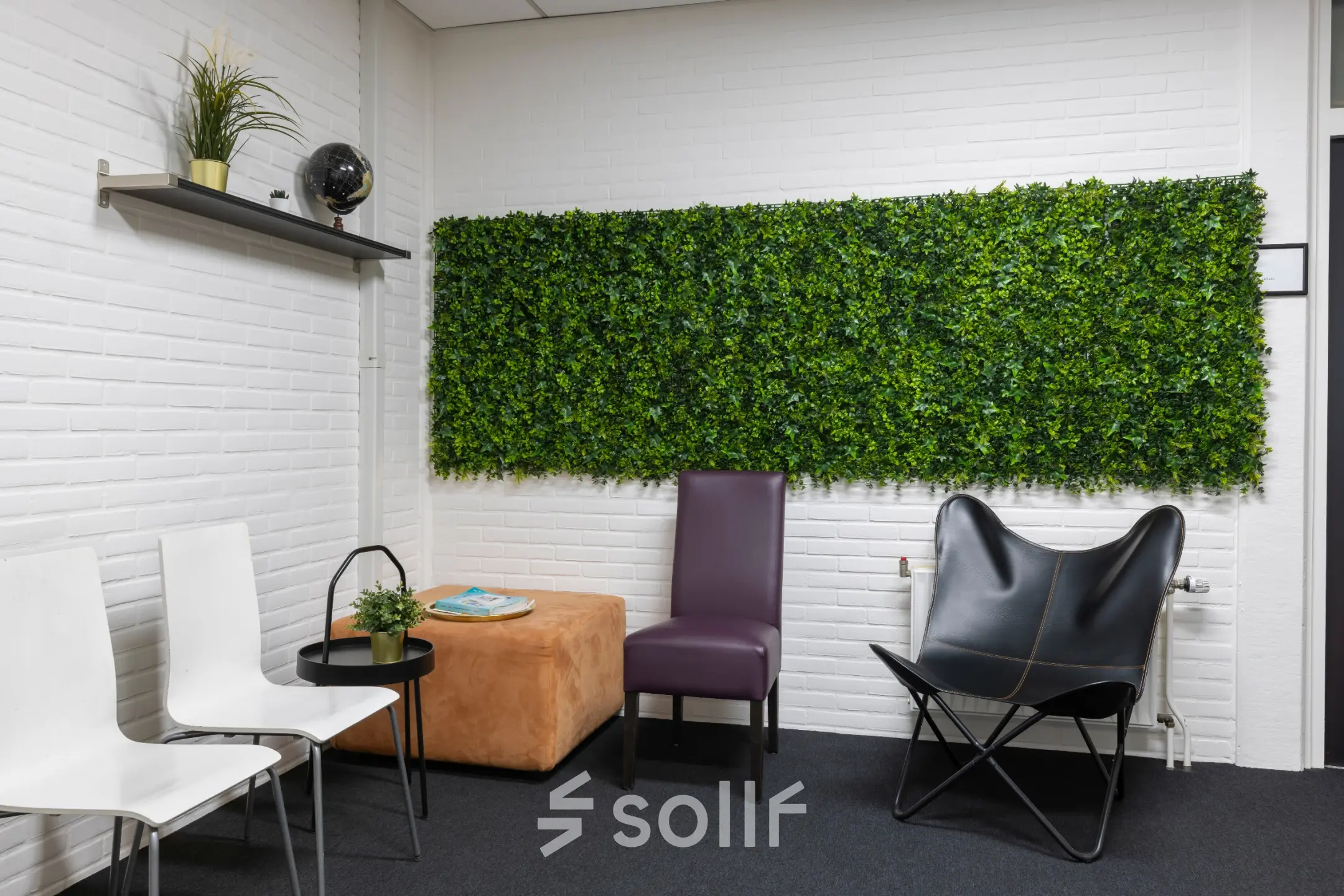 Cozy office space with seating area featuring modern chairs and a green wall decor at Zonnebaan 18, ideal for rent office space in Utrecht Lage Weide.