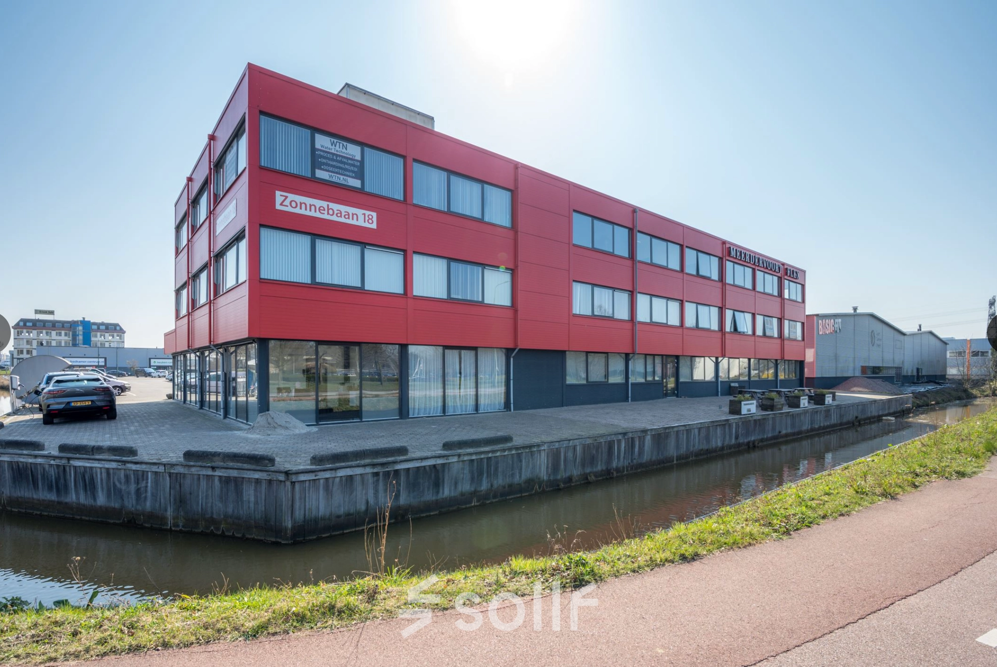 Exterior view of the red office building located at Zonnebaan 18, Utrecht Lage Weide, offering office space rental opportunities.