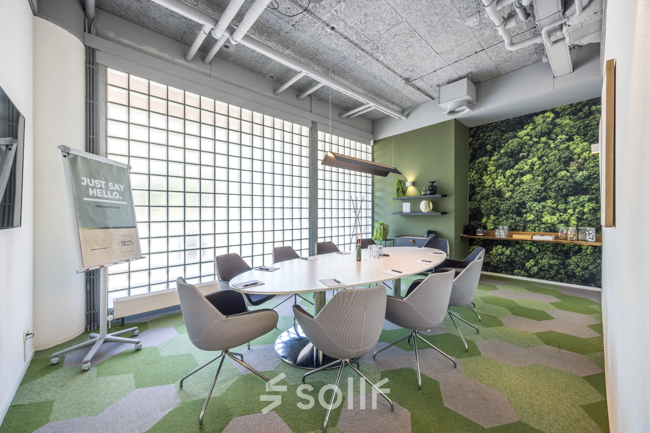 Modern office space available for rent in Utrecht North at Goeman Borgesiuslaan 77, featuring a sleek conference room with a large table, stylish chairs, and a green accent wall.
