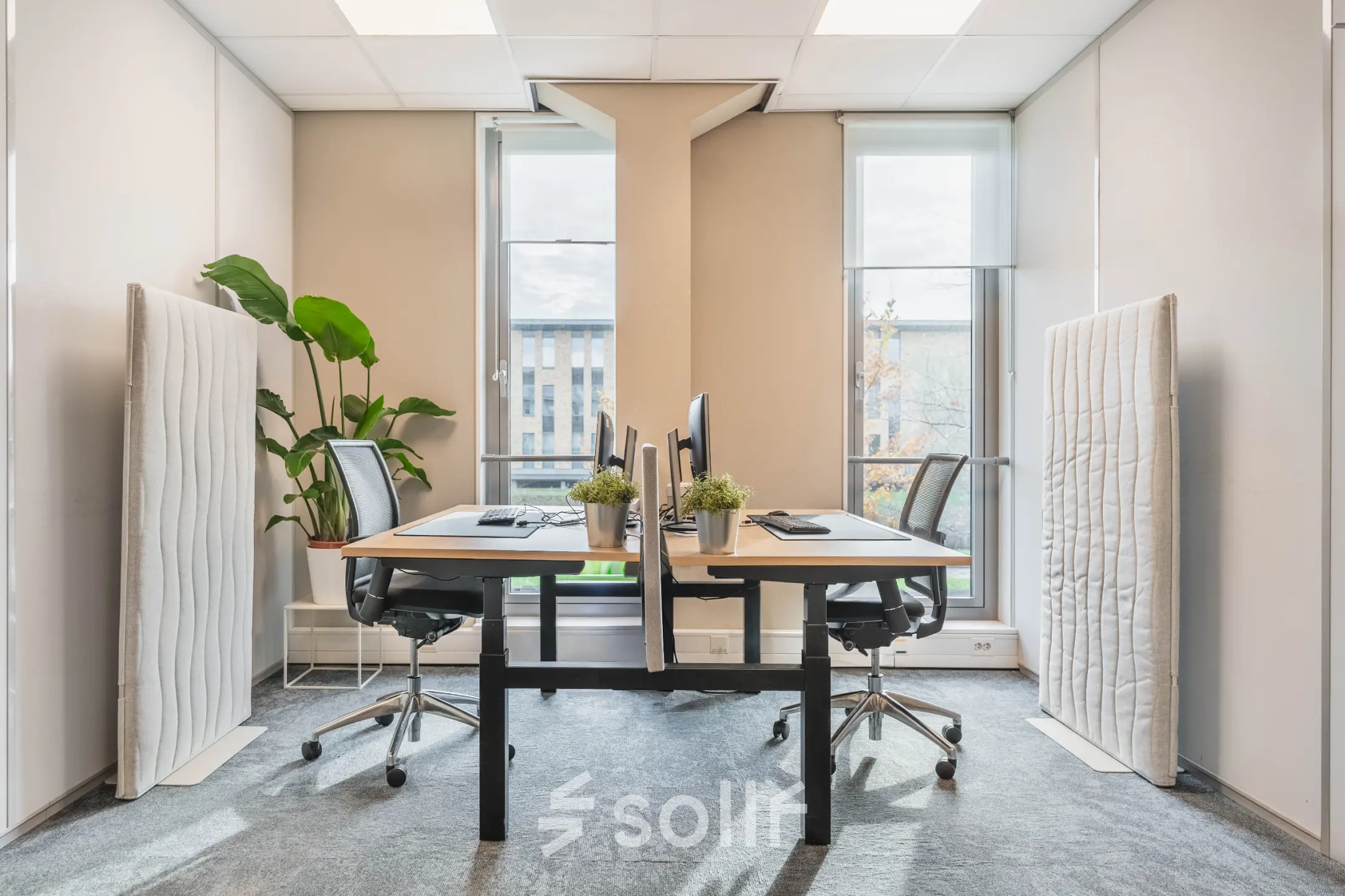 Modern office space rental in Utrecht Papendorp with large windows, two desks, and ergonomic chairs, enhancing a bright and inviting atmosphere for productivity.