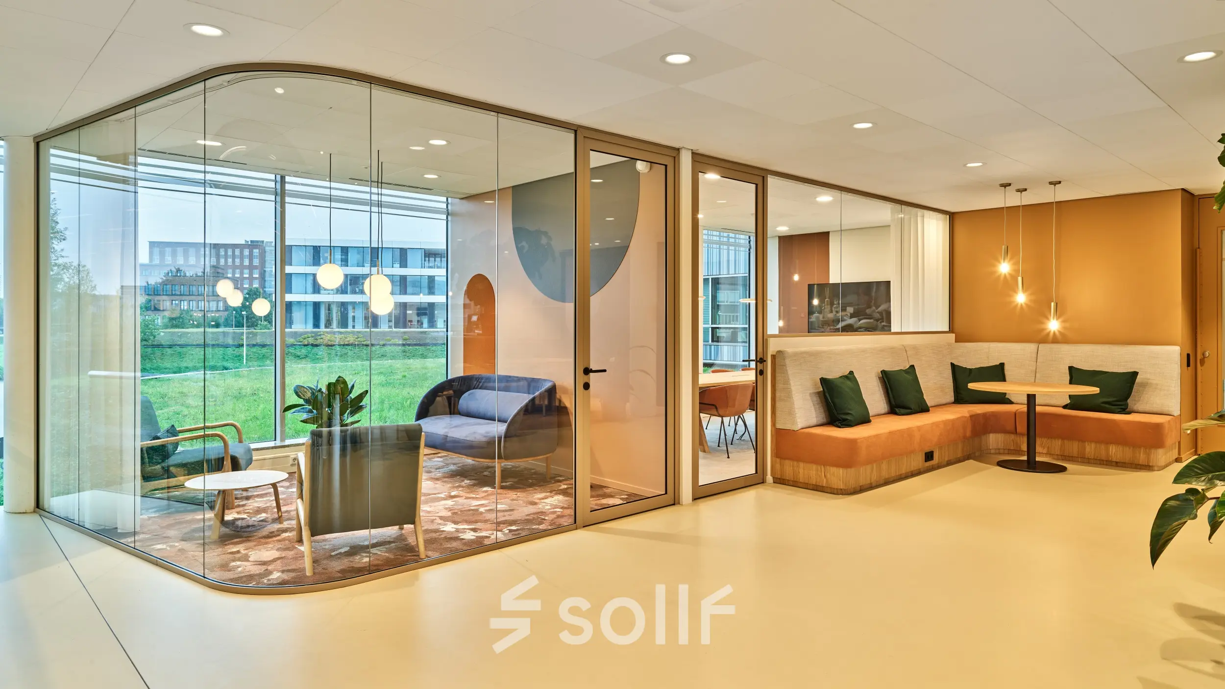 Modern and stylish office lounge with seating and a glass-enclosed meeting area at Van Deventerlaan 30-40, offering vibrant office space rental options in Utrecht Papendorp.