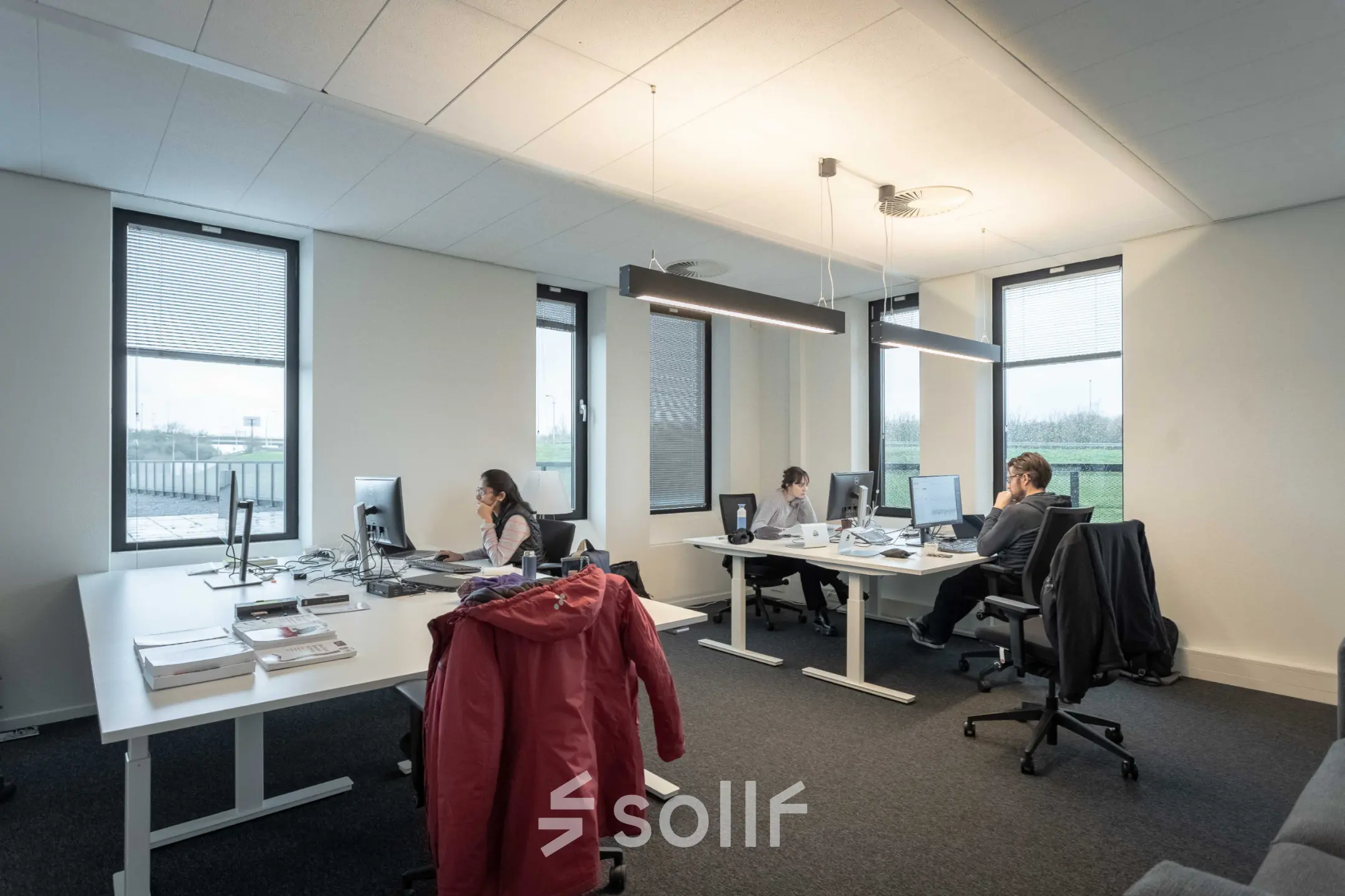 Modern office space in Utrecht Papendorp with desks and computers, featuring employees working on computers.