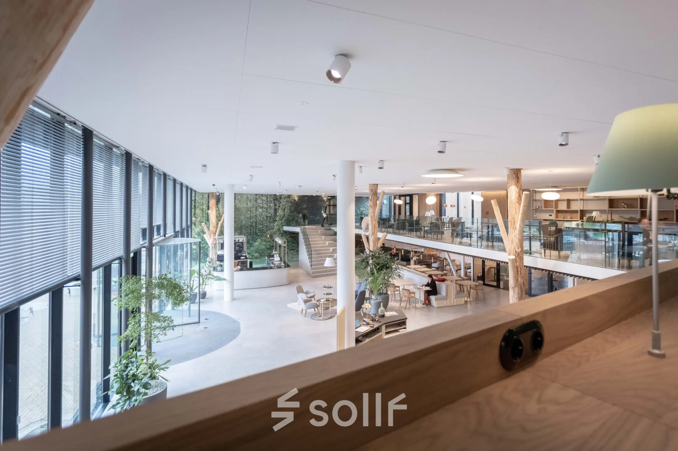 Spacious office space in Utrecht Papendorp with modern furnishings, featuring open workspaces and a loft area with business activity.